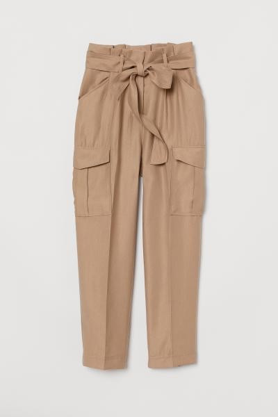 Ankle-length pants in a woven Tencel™ lyocell blend with a high paper-bag waist. Removable tie ... | H&M (US + CA)