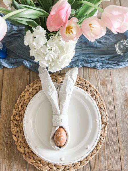 Easter table decor 🐰🌸 This spring table setting is perfect for Easter - I love the bunny napkin fold for Easter brunch. Just add fresh cut flowers to this simple spring place setting. 
.
.
Easter dinner table, farmhouse table, spring farmhouse dining room, placemat, white plates, white ceramic napkin rings, blue table runner, linen napkins

#LTKfindsunder50 #LTKhome #LTKstyletip