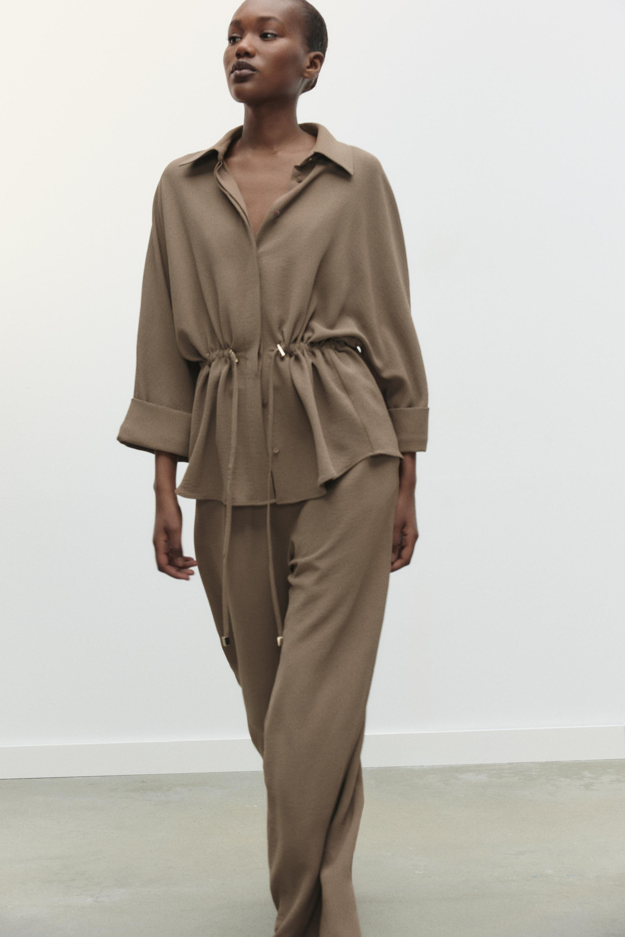 Flowing shirt with a revere collar and wide sleeves with turn-up cuffs. Drawstring waist. Conceal... | Zara UK