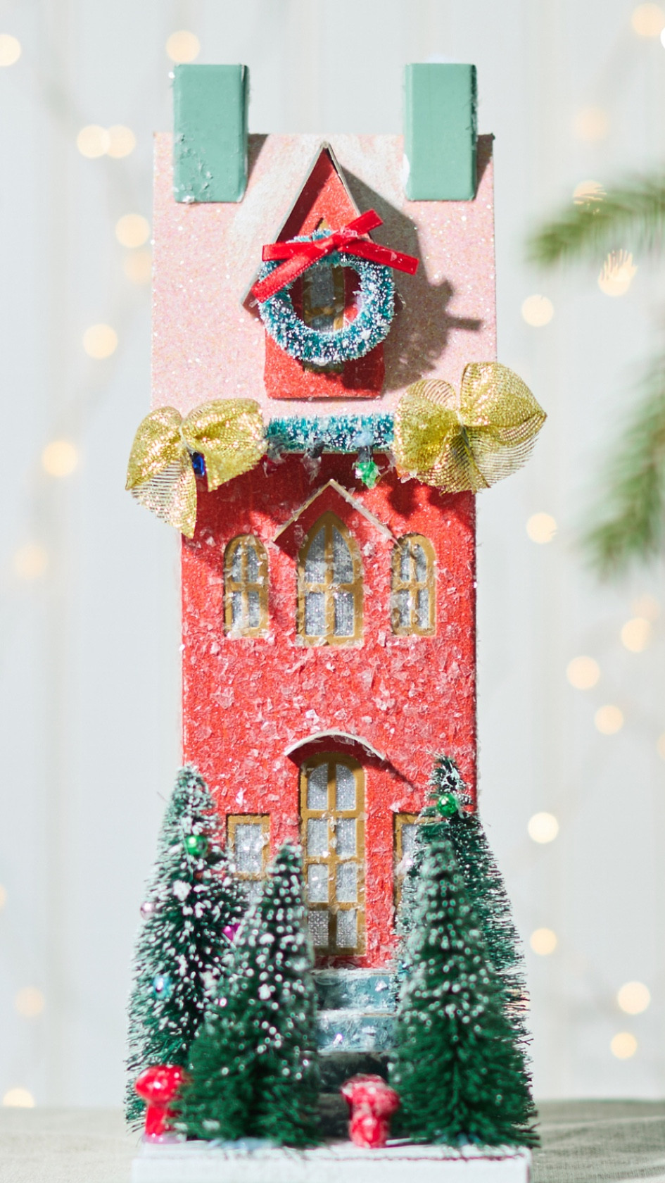 Create a charming centerpiece in your Christmas Village with this tall red townhouse. This festive townhouse is adorned with holiday decorations, including a lush wreath on the window, glowing Christmas lights, and a cozy front stairway lined with beautifully decorated trees. Its classic design and warm red color add a touch of elegance, transforming your village into a magical holiday wonderland.

#LTKHoliday #LTKHome #LTKSeasonal