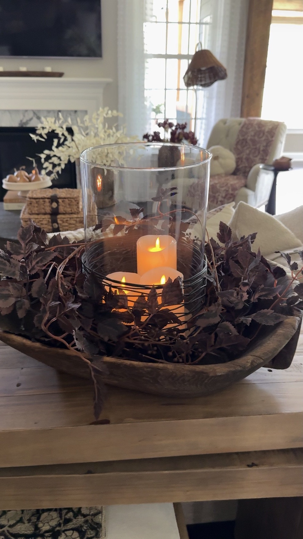 Enjoy the coziest season!!🤎🍂
For reference, I used one plum cimificuga garland to wrap around my glass cylinder. I also used a small layer of sand to hold my candles. My glass cylinder has a concave bottom and this really helps🥰

Console table, ottomans,
Fall candles, pumpkin snuffer, 100 oz fall candle, brass canister, bells with stands, vintage bowl, glass cylinder, flameless candles, plum garland, floral throw blanket, upholstered chair, round coffee table, magnetic picture lights, burgundy fall wreath, pedestal bowl, dried gourds, vintage mortar, white eucalyptus, taupe vase, toasted eucalyptus, woven storage boxes, floor lamp with woven shade, moody floral art print, floral blanket, boucle pumpkin pillow, fall pillow covers, pillow insert

#LTKstorytime #LTKSeasonal #LTKHome