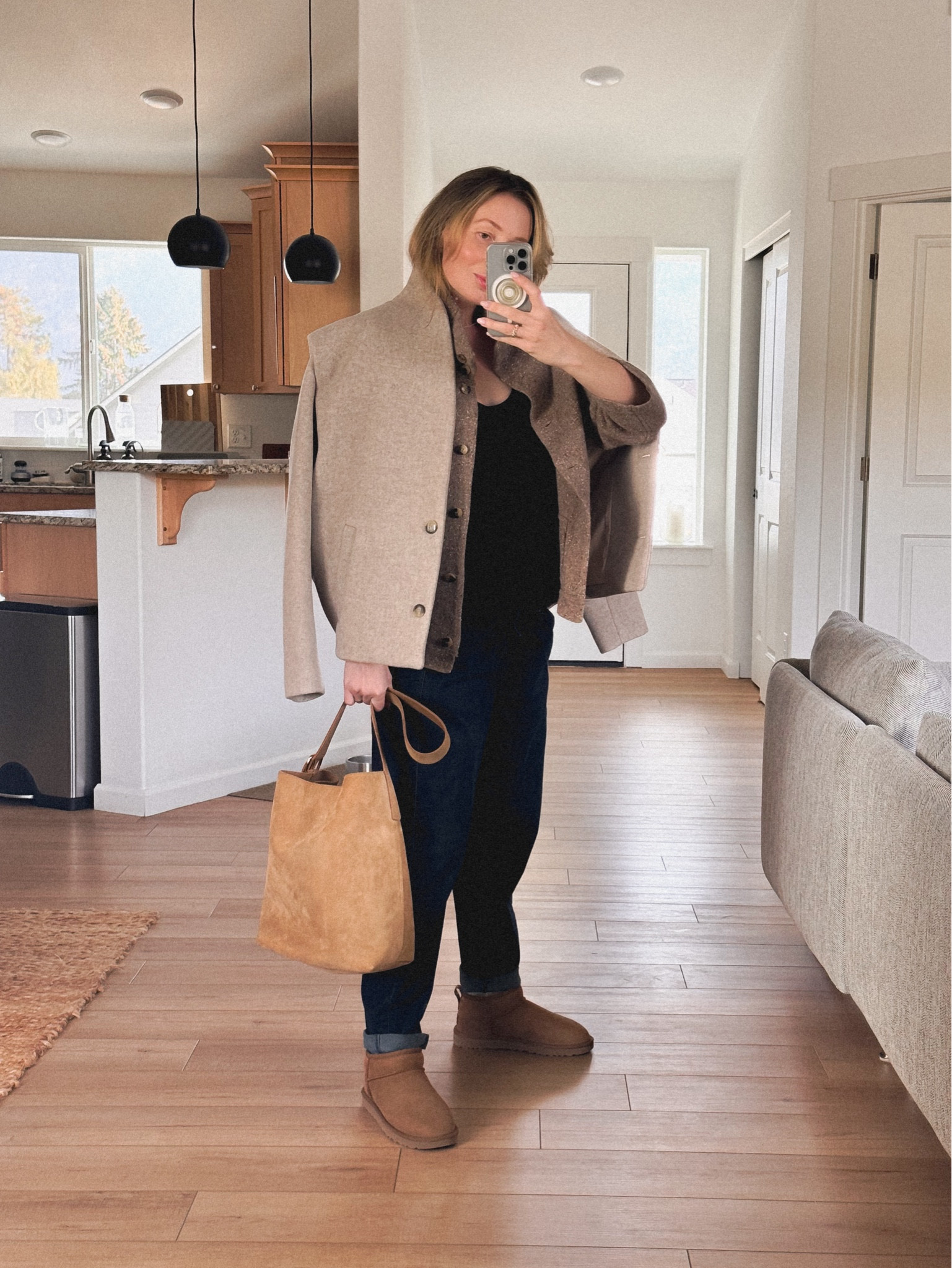 Warm and cozy vibes: OOTD: UGG mini + Eileen Fisher Jeans (in dark wash, similar jeans linked) + merino wool tank top (from Amazon) + Eileen Fisher cardigan (older model, similar linked from Sézane) + Madewell essential bucket tote in suede + Isabel Marant Etoile Drogo jacket (similar style: pea coat by &Other Stories) 

#LTKWorkwear #LTKSeasonal #LTKStyleTip