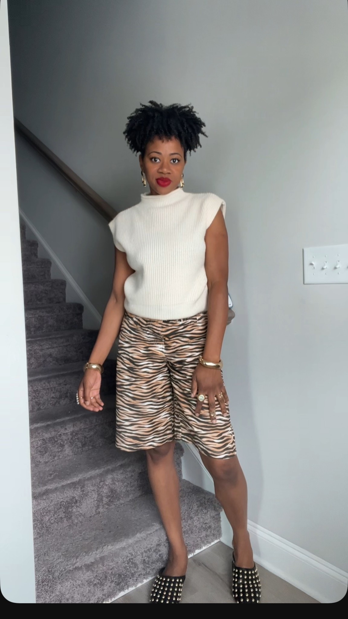 Jorts fall outfit inspo. Animal print jorts with sweater and black mules. 