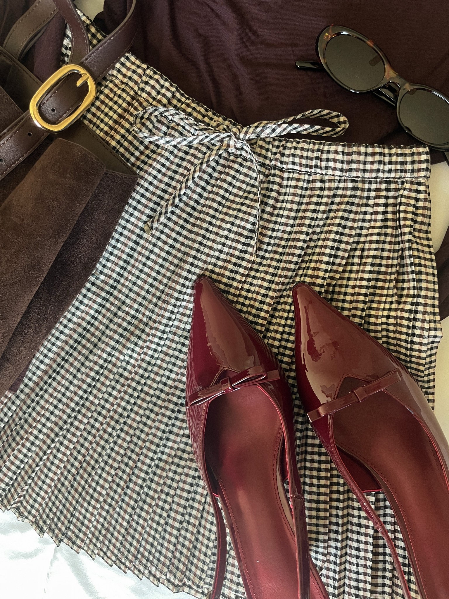 Pleated plaid skirt, burgundy kitten heels, dark brown suede tote, draped brown top 

#LTKStyleTip #LTKSeasonal #LTKFindsUnder50