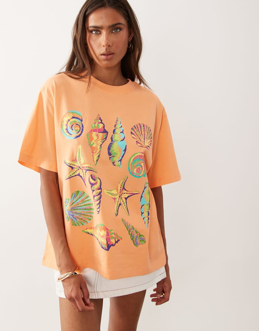 ASOS DESIGN Oversized T-shirt with neon shell graphic in coral-Orange | ASOS (Global)