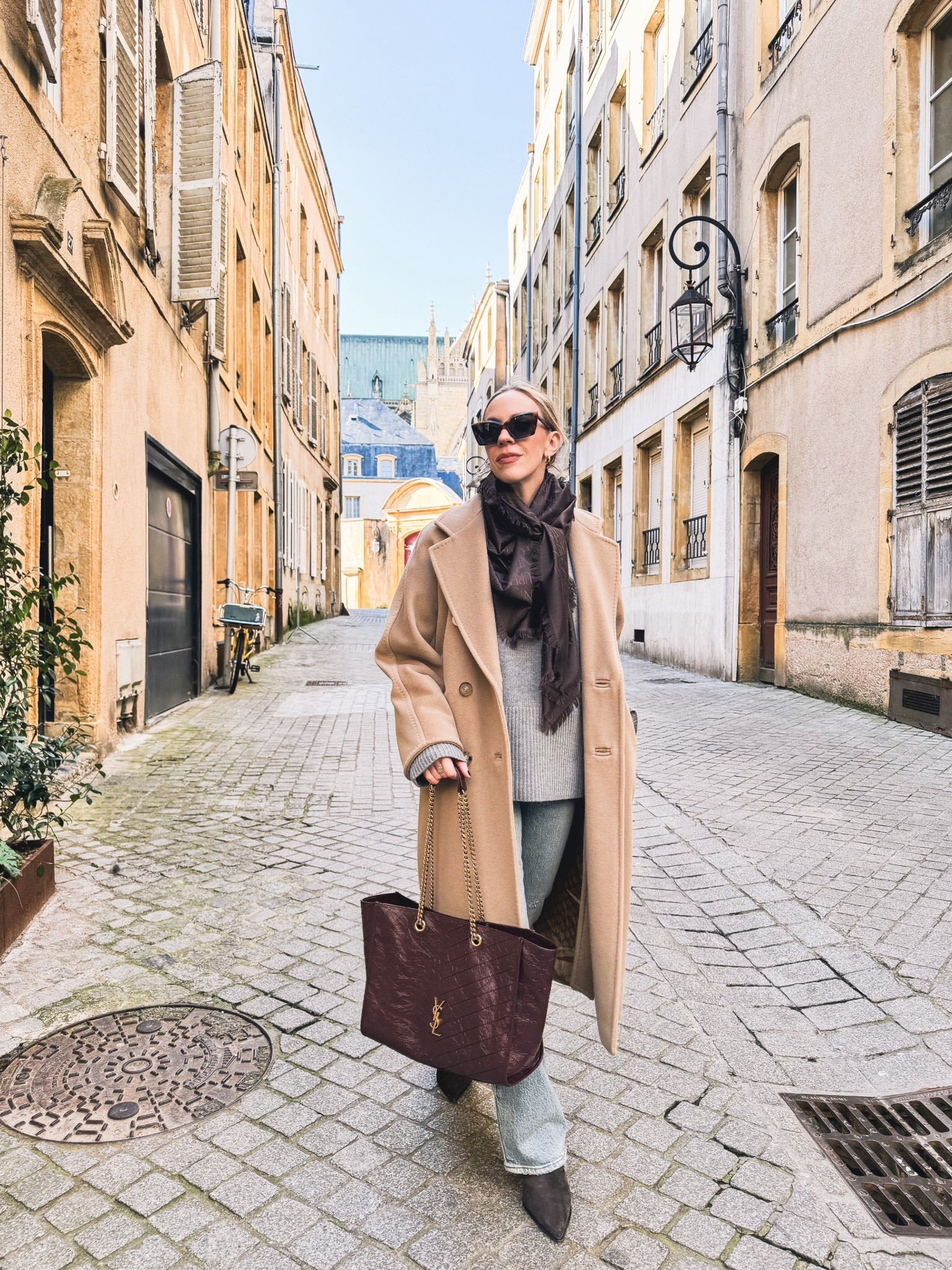 European travel look, camel
coat, Saint Laurent monogrammed scarf, @Levi's bootcut jeans, burgundy YSL tote bag

#LTKOver40 #LTKTravel #LTKSeasonal