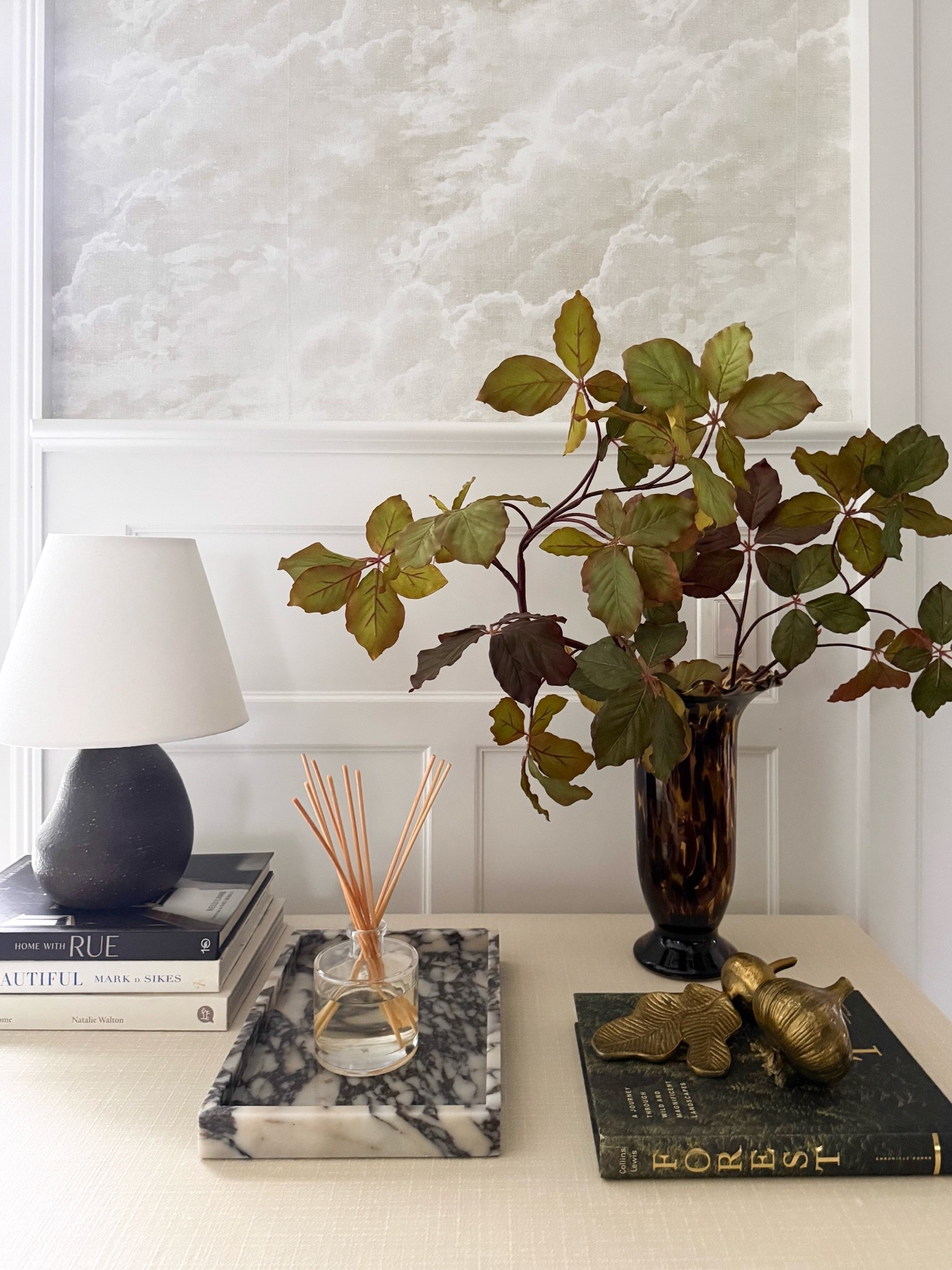 A little fall console styling with some of my favorite layers. The tortoise shell vase, seasonal branches, marble tray, warm brass accents, and stacked books bring in just enough color and texture without making the space feel overly seasonal.

fall console decor, tortoise shell vase, faux fall branches, marble tray, brass home accents, console table styling, fall home decor, neutral fall decor, coffee table books, layered home decor, timeless interiors, girlonthehudson

#LTKSeasonal #LTKHome #LTKdayinmylife