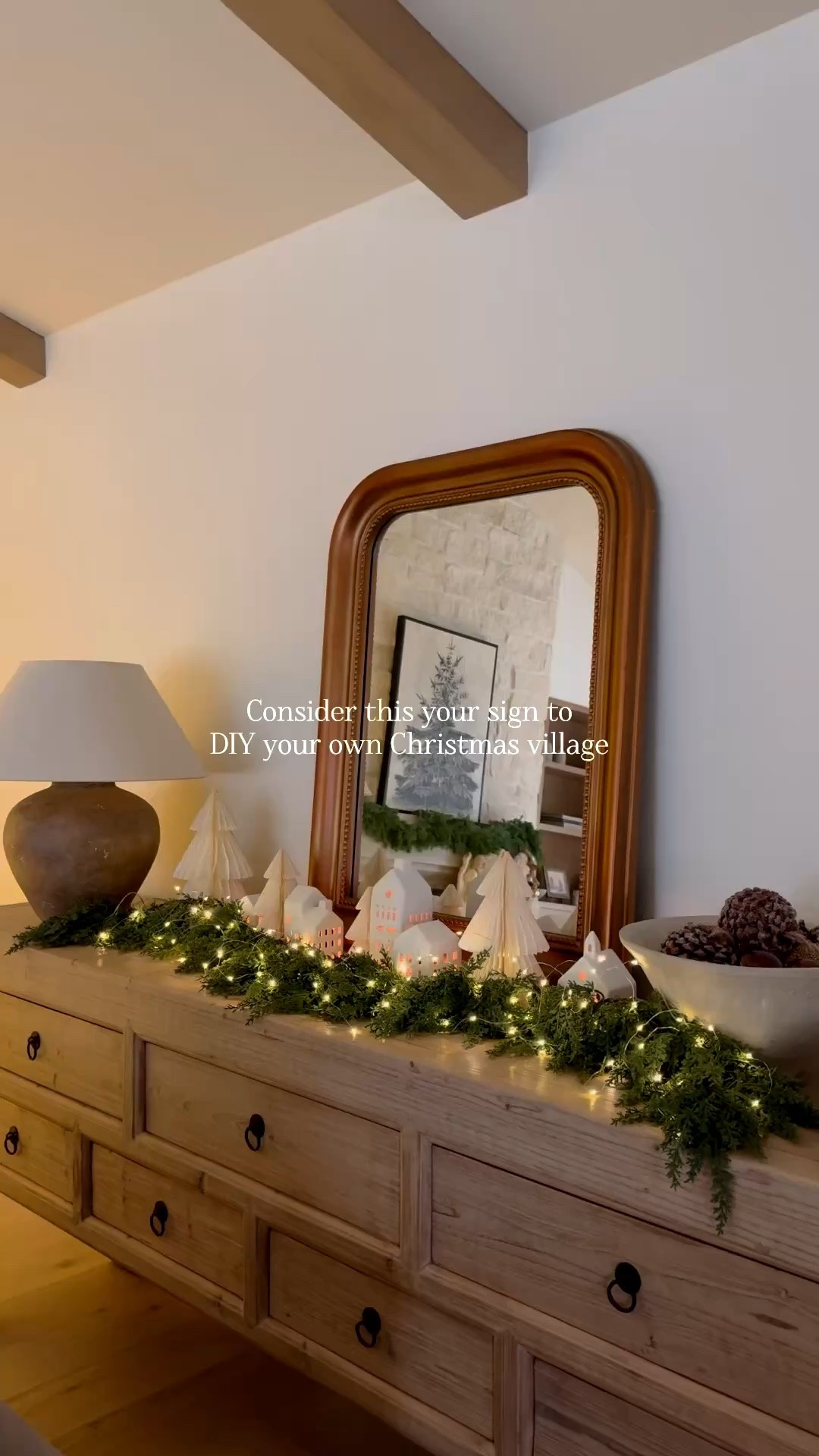 A little Christmas village magic! ✨🎄 Layered garland, ceramic houses, mini trees, and twinkle lights to create the coziest holiday display. Linking everything I used to recreate the look! 🤎

#ChristmasDecor #ChristmasVillage #HolidayStyling #ChristmasHomeDecor