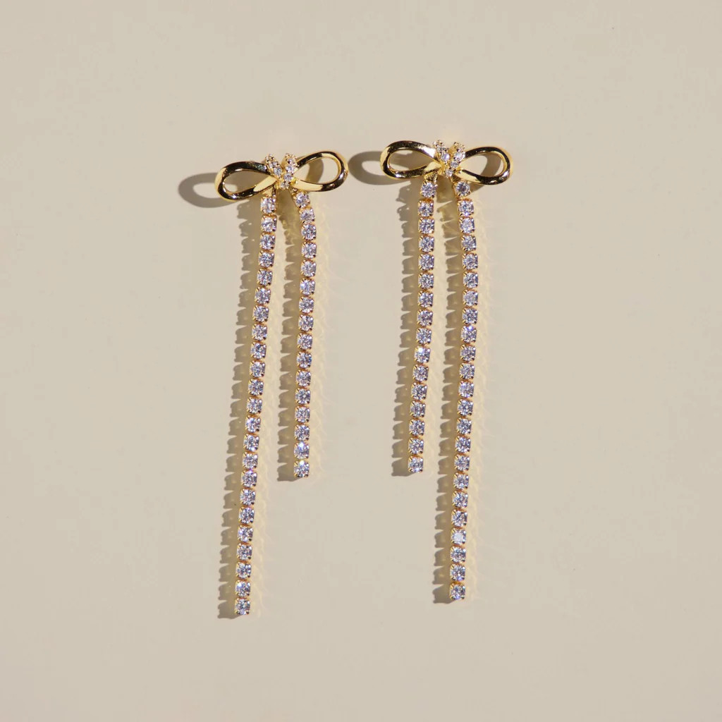 Gold Long Crystal Bow Drop Studs | Nickel and Suede