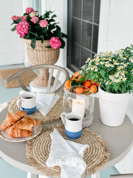 Coffee on the front porch, outdoor dining table and chairs, Al fresco dining, entertaining, wicker planter, coffee mugs, blue and white, juliska, scalloped planter 

#LTKhome