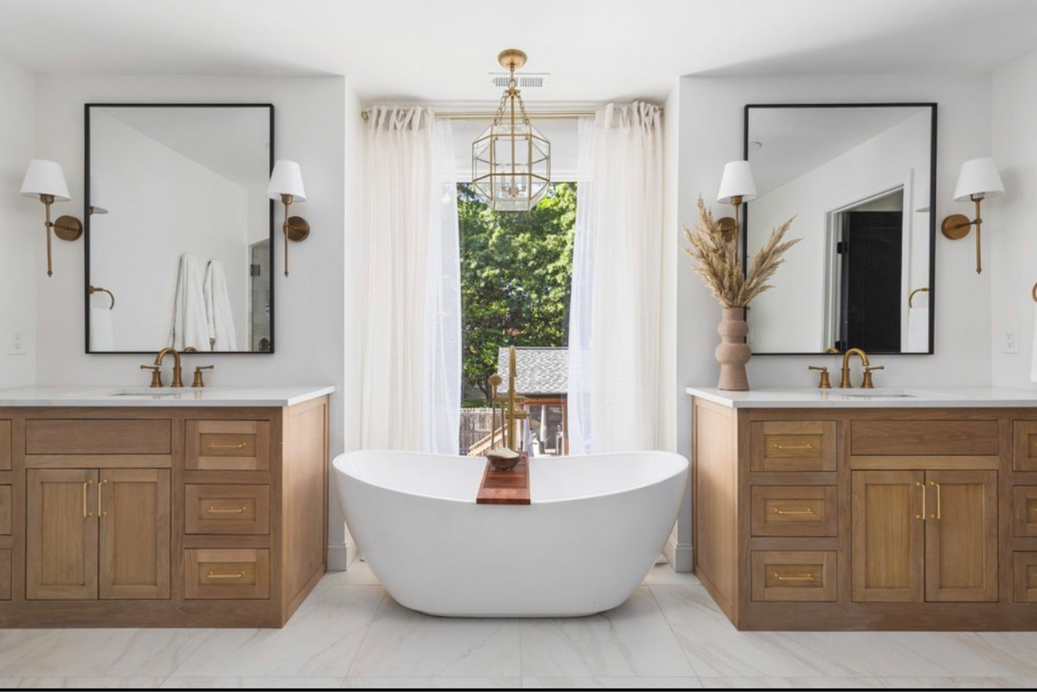 I absolutely love how our master bathroom came out. Shop all the things here! The vanities are custom white oak - however I linked one very similar if you didn’t want to go custom! These mirrors are my absolute favorite! I love how big they are! This chandelier and the tub is so quaint! 

60 inch single vanity 
Bath tub
Chandelier 
Vanities
Mirror
Sconce lighting
Faucet 
Tub caddy 
Primary bath 
Luxury bathroom 

#LTKHome #LTKStyleTip #LTKU