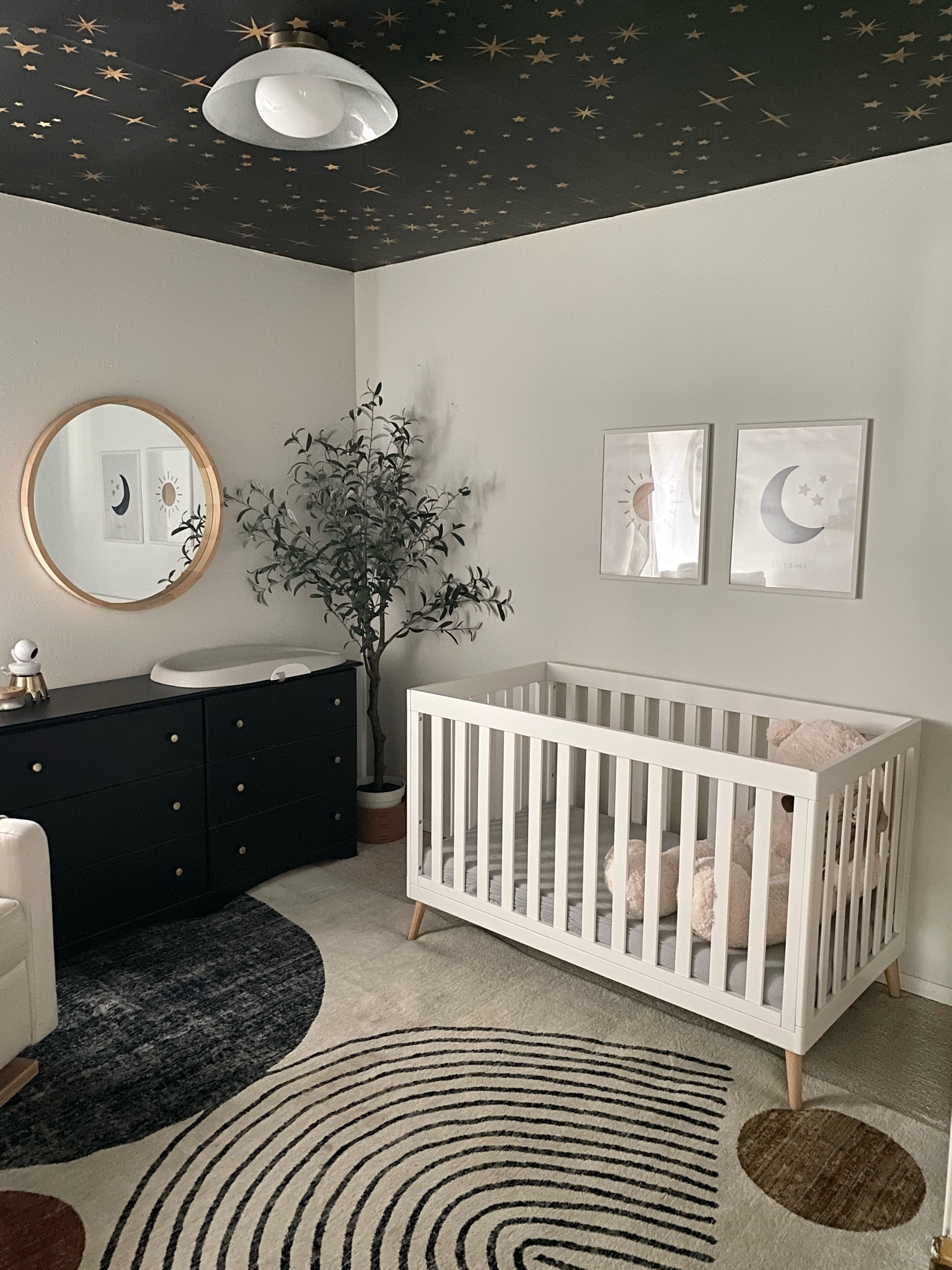 My baby boy’s little dreamer nursery! 💫🌠☁️🌑☀️ moody, modern, sophisticated and playful nursery interior design. Ceiling wallpaper, moon themed light fixture, abstract area rug and more linked! 

#LTKBaby #LTKHome