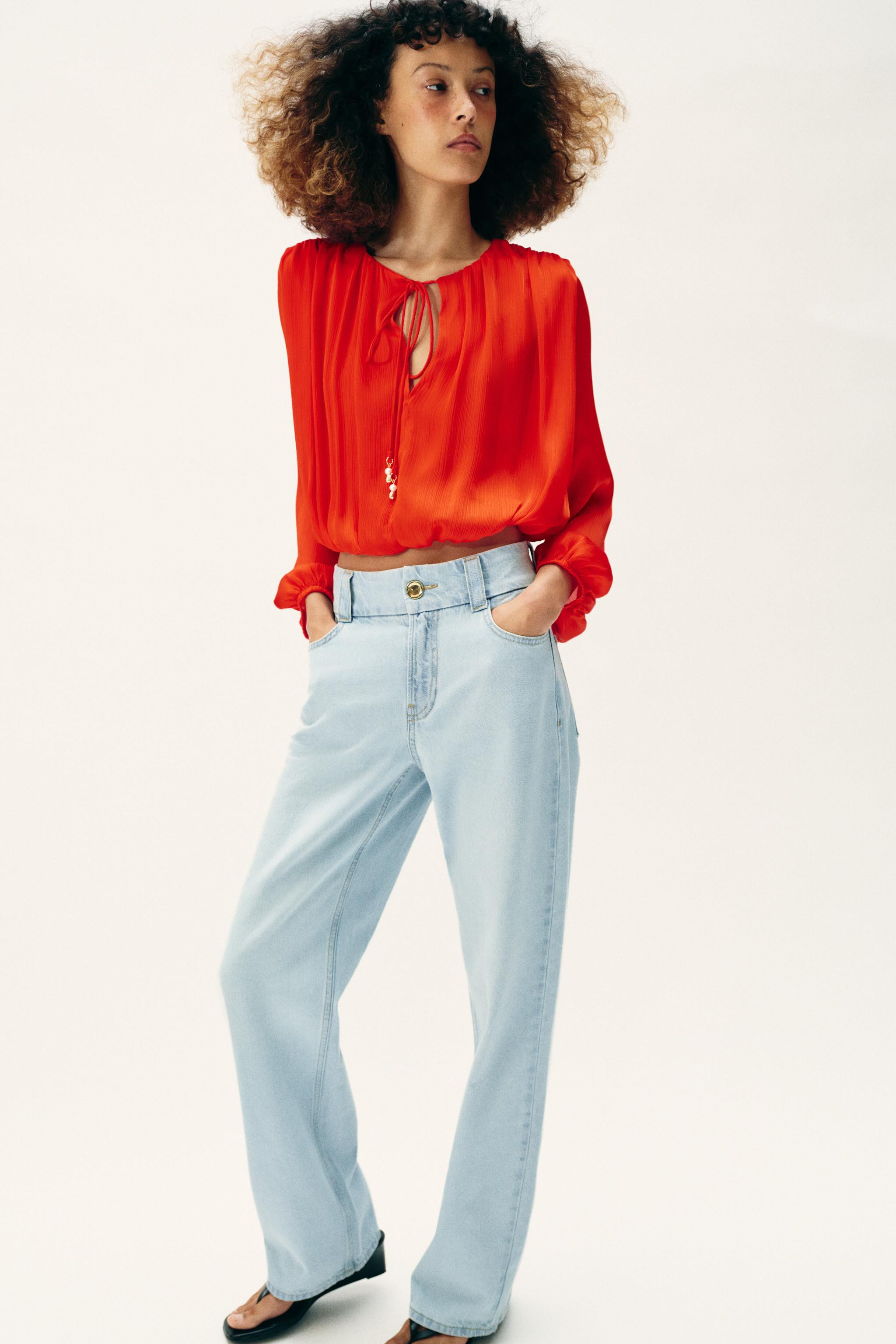 Cropped round neck blouse with beaded drawstring. V-neckline and long sleeves with elastic cuffs.... | Zara US