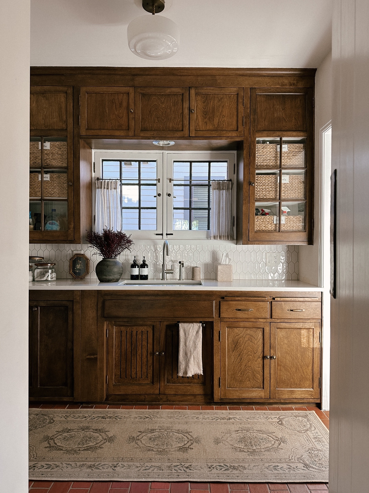 Had lots of questions about the cafe curtain in my reel this week. I did a no sew project to hem them. Linking the curtains, rings, DIY tools and similar rods since ours is original to our home. *laundry room, window treatments, washable rug, glass canisters, faucet, backsplash tile, soap dispenser, flush mount lighting  

#LTKhome #LTKstyletip