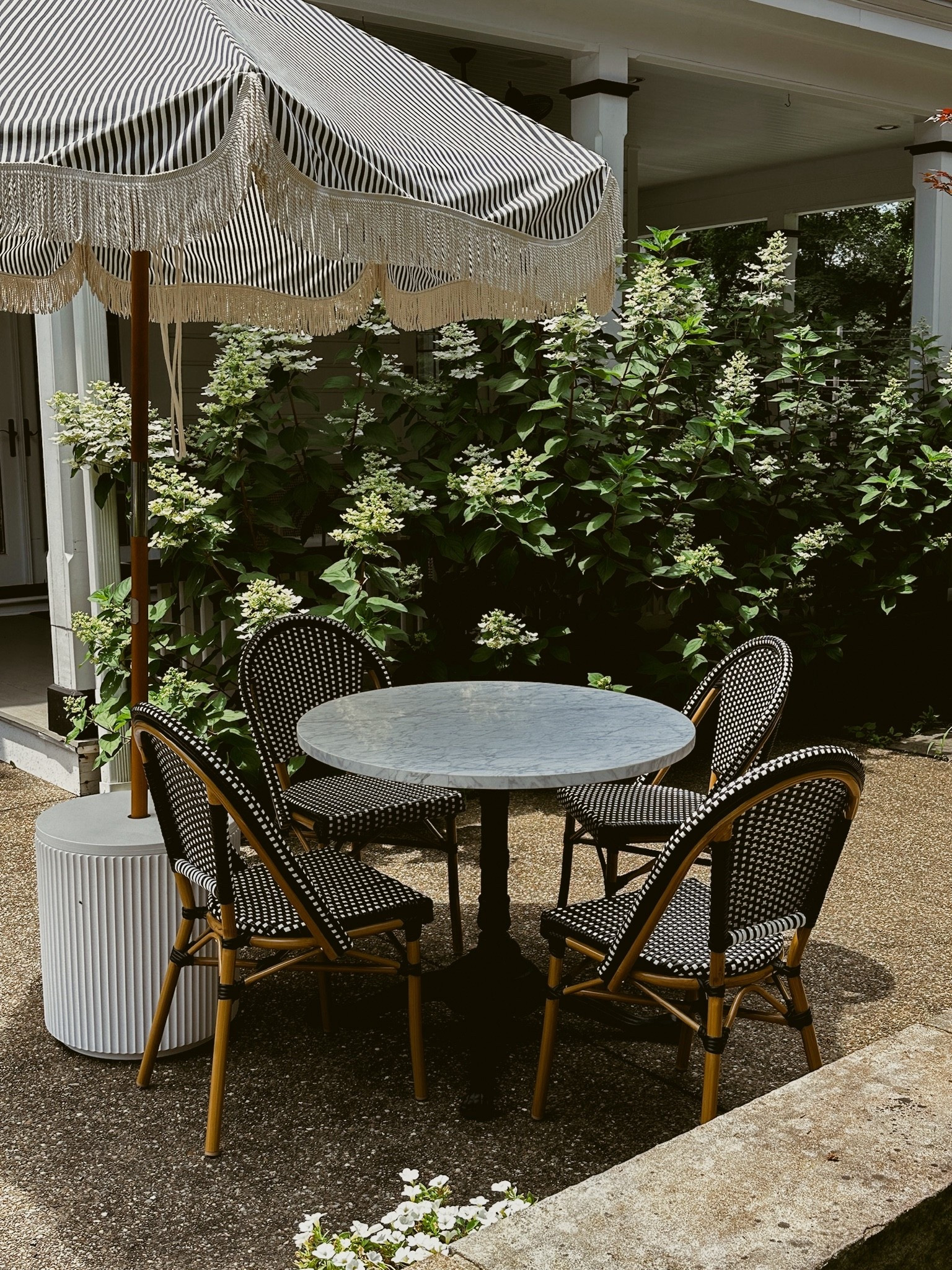 French Bistro marble outdoor table bistro set black wicker chairs striped umbrella fringe umbrella holder 



#LTKSeasonal #LTKHome