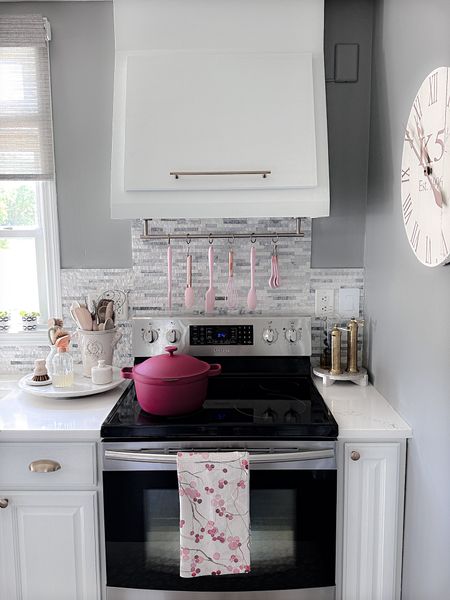 Kitchen details 
Champagne brass knobs and pulls 
Pink soup pot 
Our place perfect pot 
Pink utensils 
Marble lazy susan
Brass salt and pepper mills
