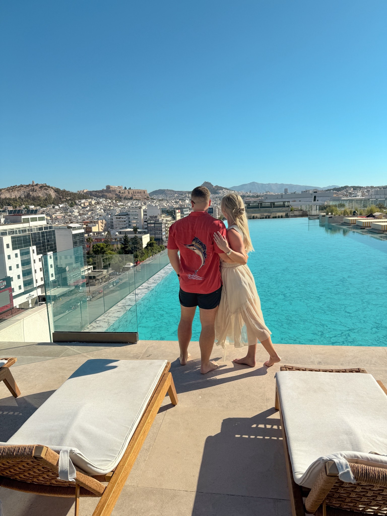 Poolside perfection in Athens 💙🇬🇷 Golden hour swims, matching linen looks, &amp; Acropolis views — this is how we do European summer style. From resort days to rooftop cocktails, these are the kind of effortless outfits you’ll want to pack for your next Greece getaway. Save this post for couples outfit inspo &amp; follow @kitchensinkit for luxury travel fashion from Greece to Cabo ✨ Athens poolside outfits, Greece resort wear, European summer style, couples resort outfits, matching vacation outfits, Greece honeymoon outfits, Athens rooftop pool fashion, luxury resort style, Mediterranean outfit ideas, neutral resort wear, men’s linen shirt outfit, women’s summer dress outfit, European vacation looks, stylish outfits for Greece, summer in Athens outfit ideas, coastal couples fashion, Greece travel style, chic summer outfit inspo, resort wear for couples, honeymoon travel outfits, blue and white resort fashion, neutral linen outfit Greece, what to wear in Athens summer, luxury travel style

 

 #LTKSwim #LTKTravel #LTKMens