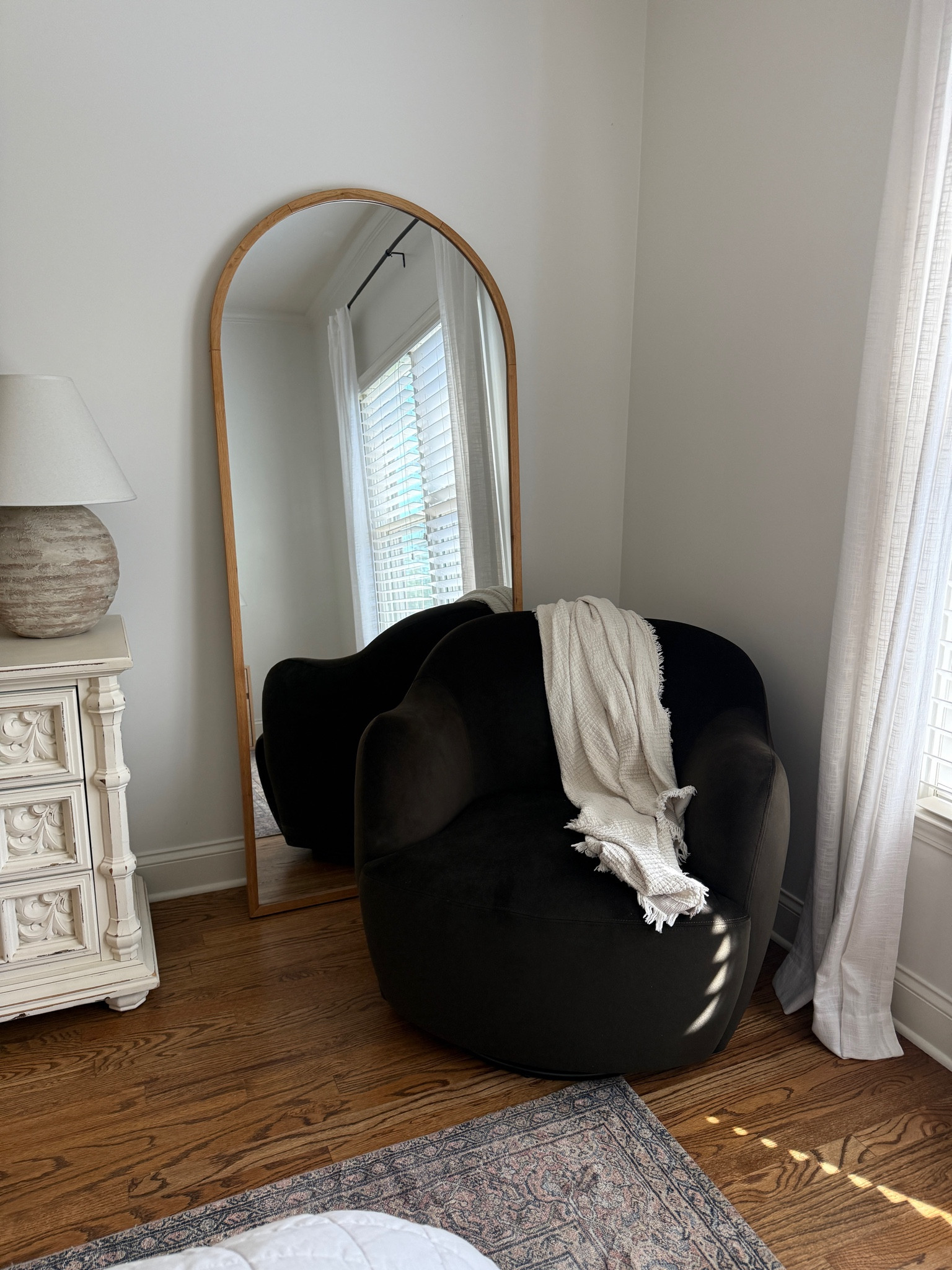 Swivel chair and arched mirror