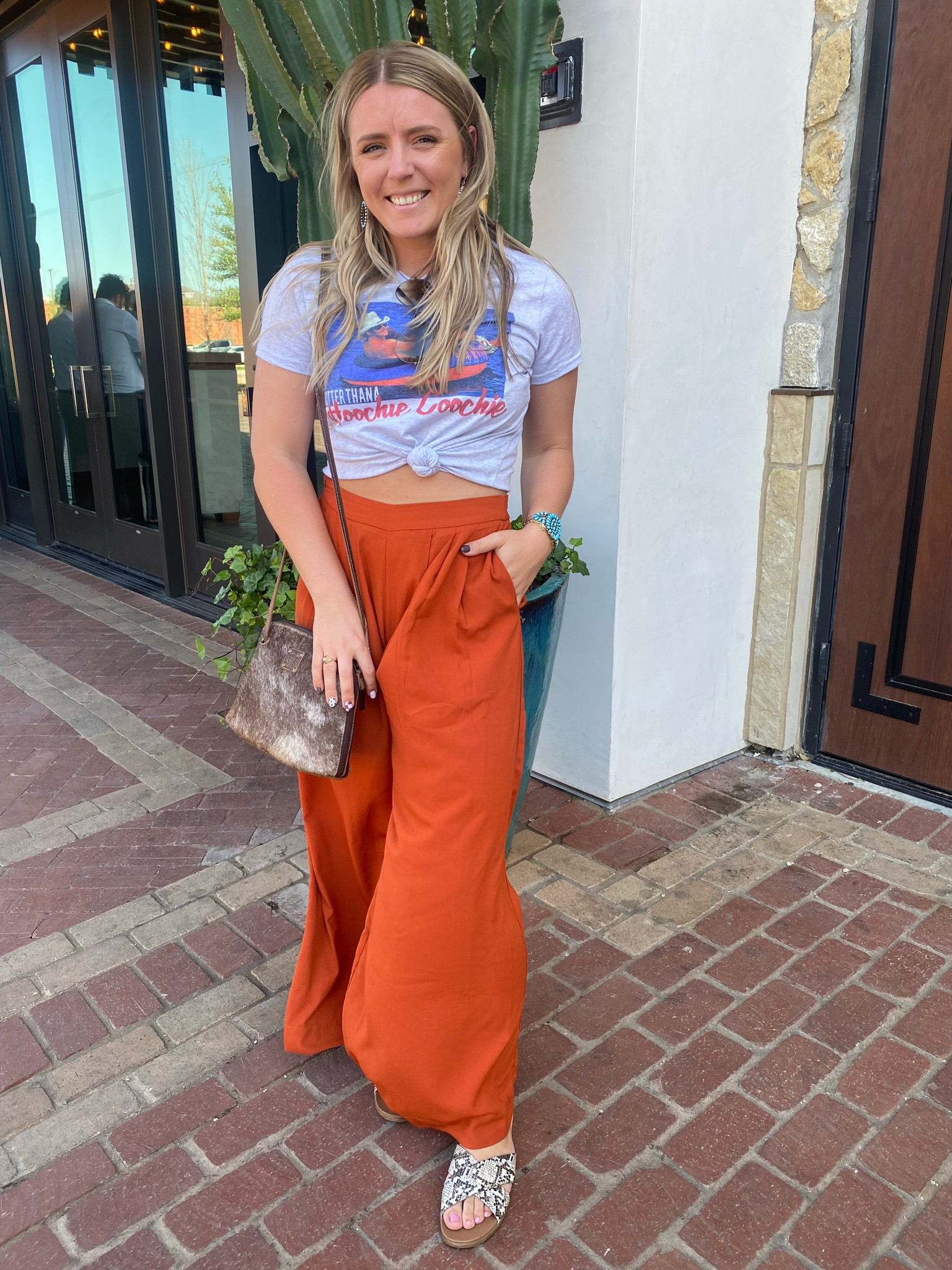 One of my go to casual cowgirl looks! Graphic tee, wide leg pants, printed slides, and of course turquoise & cowhide for the accessories!

#LTKstyletip #LTKtravel #LTKsalealert