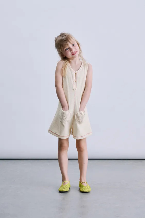 Short towelling playsuit with a round neck and sleeveless design. Featuring tear-drop button fast... | Zara UK