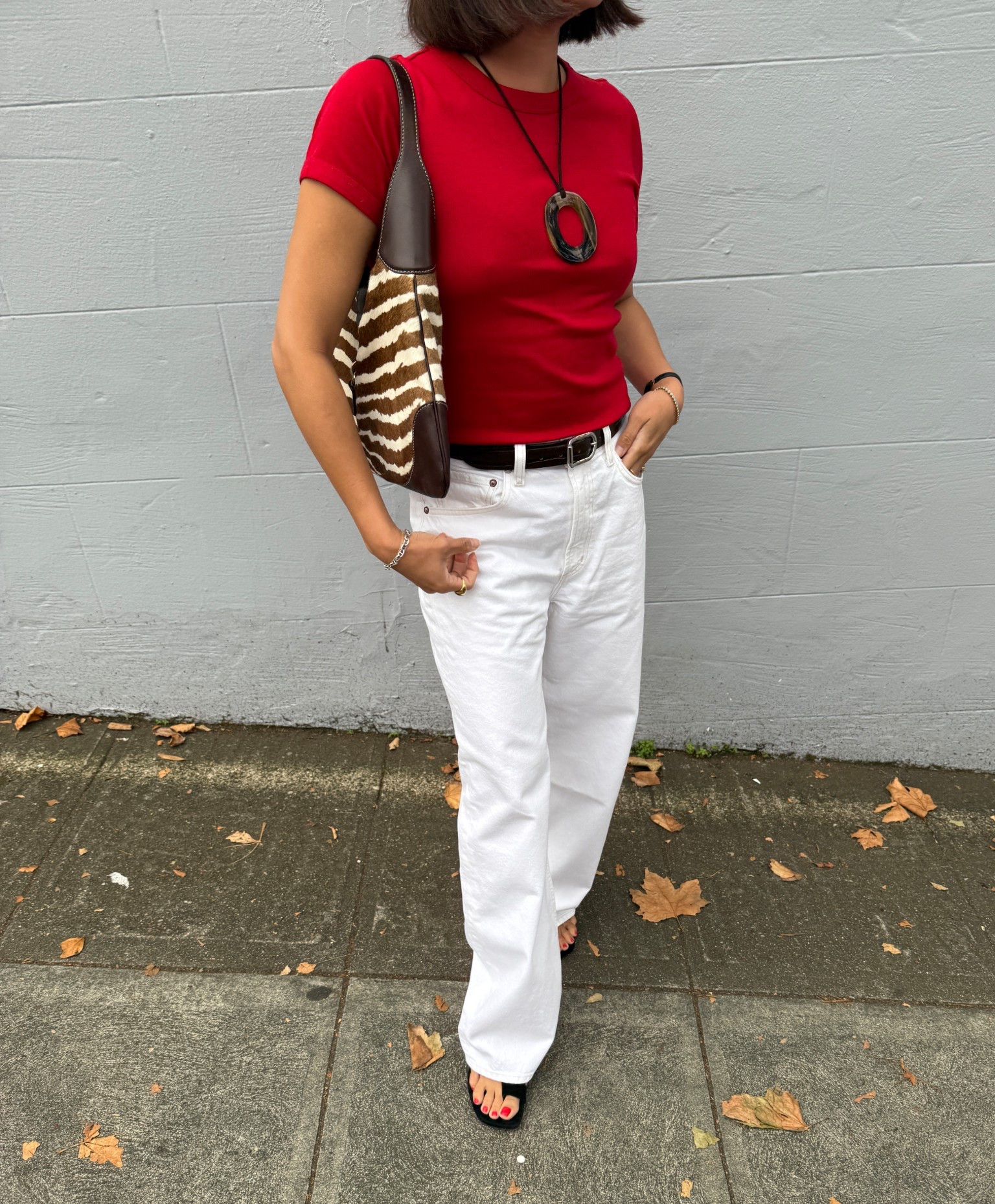 Transitional outfit idea: red tee, white denim, brown accessories, zebra pony hair bag 

 #LTKStyleTip #LTKSeasonal #LTKItBag