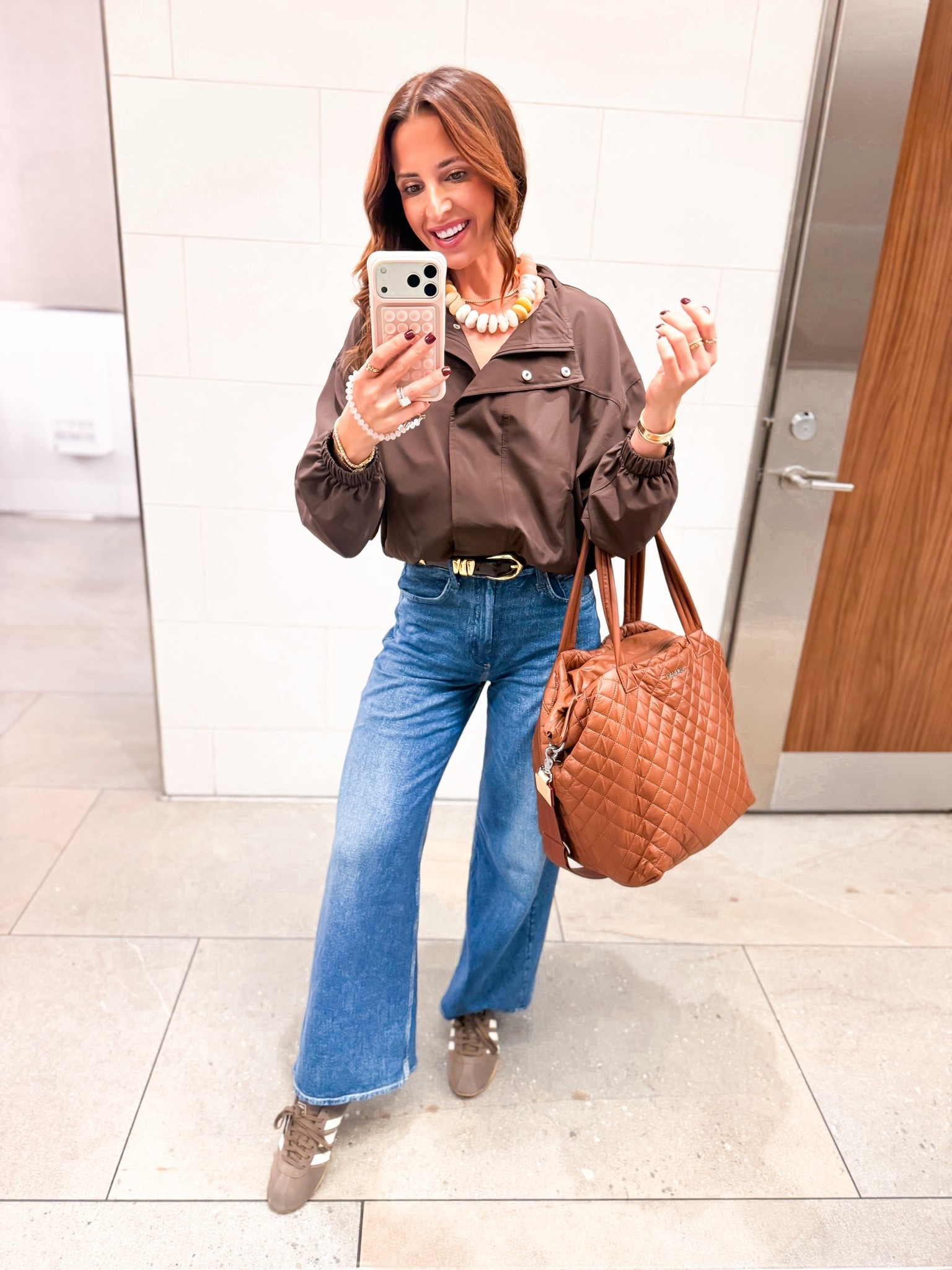 My airport outfit of the day. Travel outfit. Elevated casual outfit. rb Miramar Sofie Ankle-Length Pants in 23 (most people size down 1 in these and that’s what I did). Linking full length option, too! Chocolate brown balloon jacket in quick dry material, size XXS. Seamless bodysuit in XS. Brown adidas - I sized down half a size. Beis luggage sets with matching covers. MZ Wallace quilted tote in medium, color is ‘terracotta’.