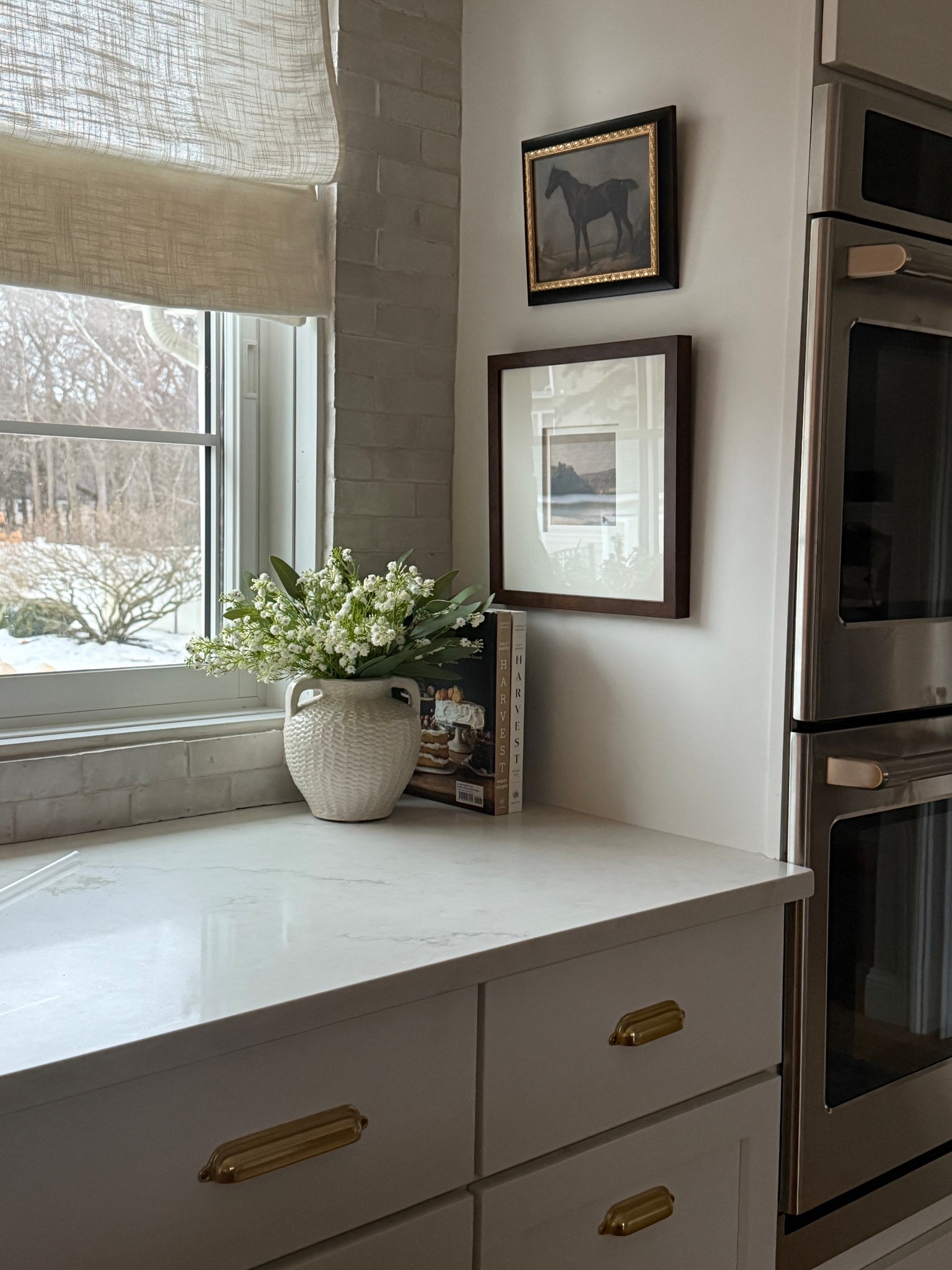 Adding some detail to this corner of my kitchen. There is a being good size area and I have been wanting to add some interest here. I am liking the wood frame for some warmth and dark art. Added a pretty vase and some flowers!

#LTKHome #LTKFindsUnder50