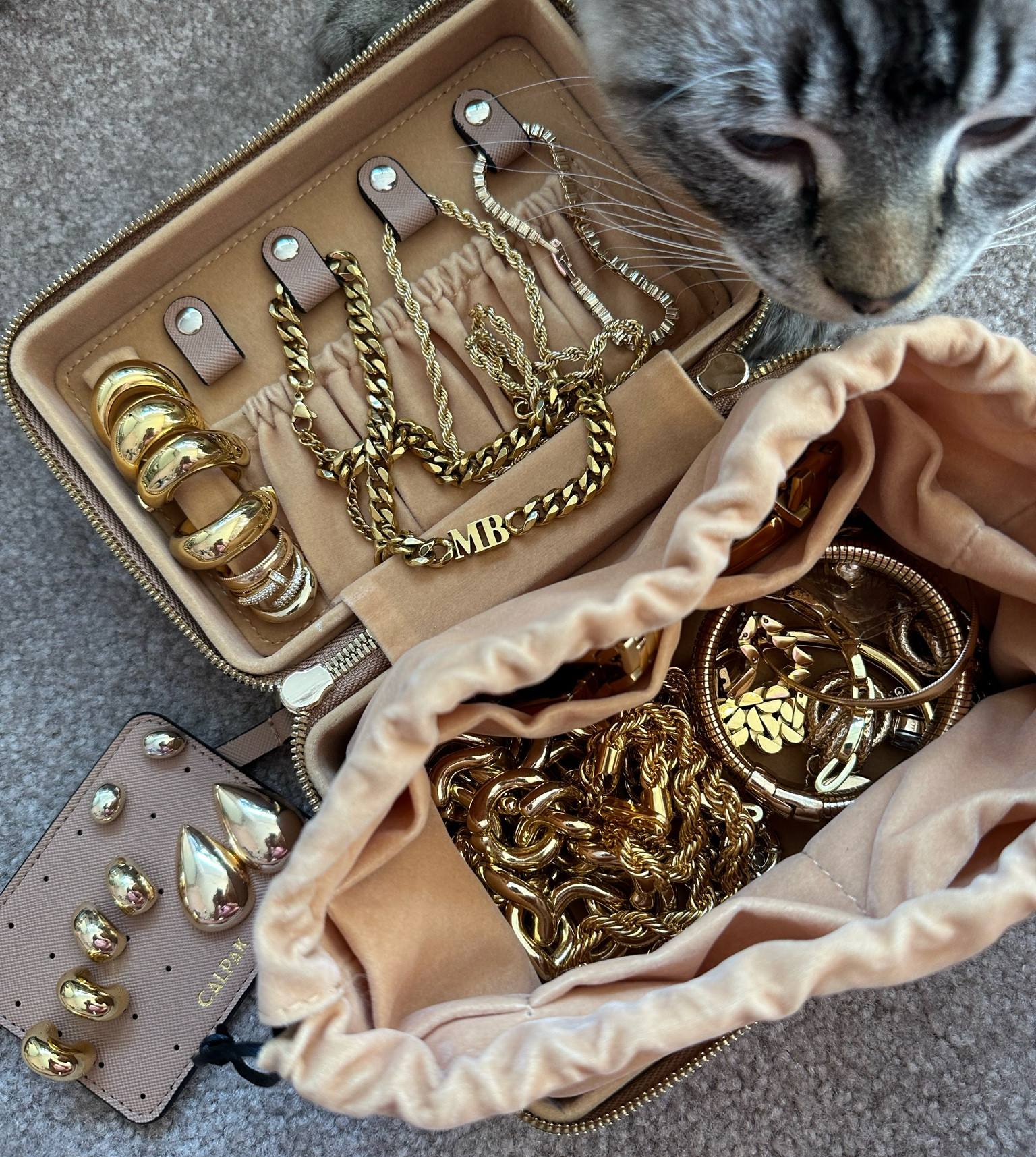 New CALPAK travel jewelry case! 
Mine is in the color Mauve. 

• Faux Leather Exterior 
• Faux Suede Interior 
• Easy Access Zip-Around Opening 
• Snap Tabs for Rings and Necklaces 
• 28-Hole Earring Card 
• Large Drawstring Pocket
• Covered by the 1-Year Limited CALPAK Warrant