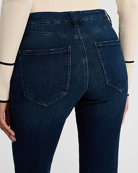 Mid Rise Dark Wash Raw Hem FlexX '70s Flare Jeans | Express