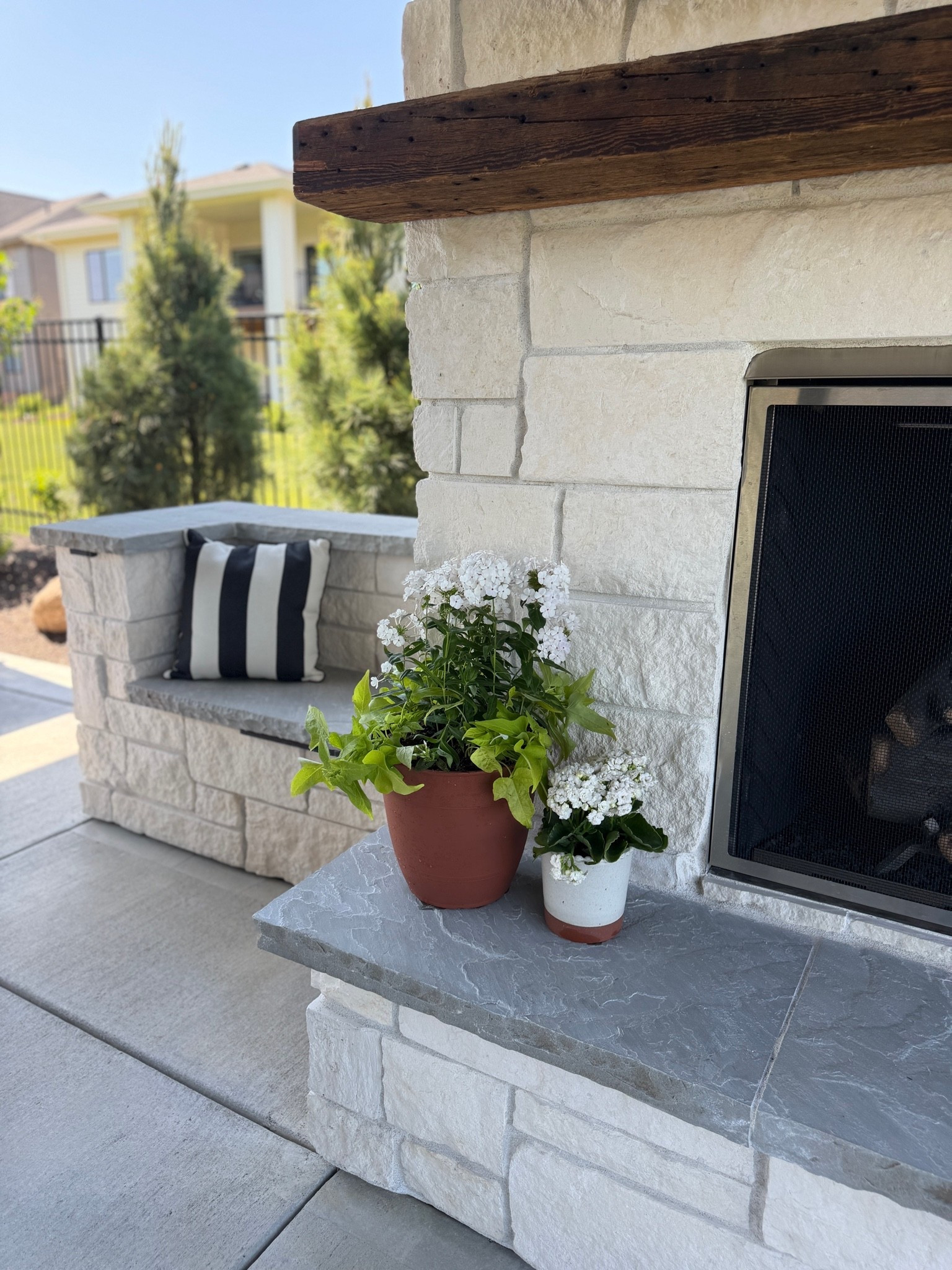 Added some new potted flowers to the outdoor fireplace! Love mixing in the neutral tones with the white flowers.

#LTKHome #LTKOver40 #LTKSeasonal