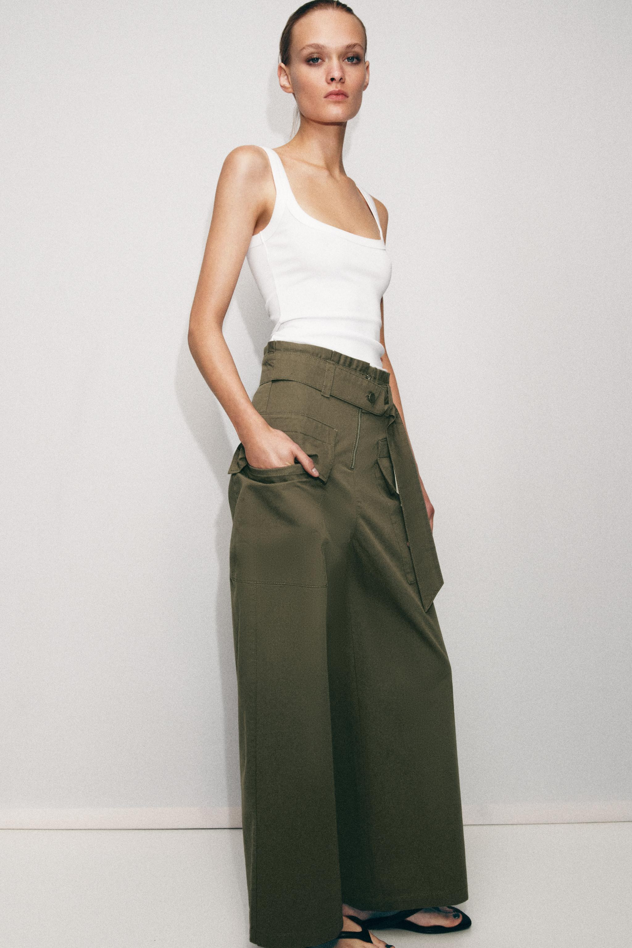Model height: 176 cmHigh-waisted pants with pleats and belt. Side patch pockets with flap. Wide l... | Zara Canada