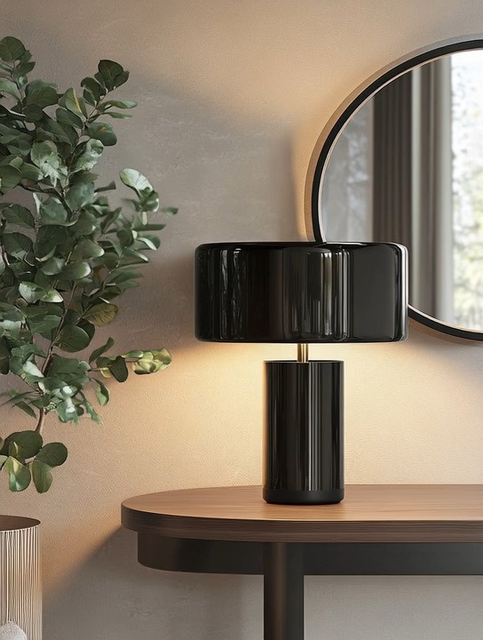 This modern black table lamp is one of those effortless pieces that instantly elevates any space. Styled on a console table, side table, or home library, it adds a layer of quiet glamour without overwhelming the room. The sculptural silhouette and glossy finish feel refined, elegant, and intentional—perfect for interiors that blend modern design with classic elements.

What makes this lamp stand out is its versatility. It works beautifully in living rooms, bedrooms, entryways, or reading corners, adding warmth, depth, and a polished finish. Whether your home leans contemporary, transitional, or softly traditional, this table lamp brings balance and a subtle statement that feels timeless rather than trendy.

#ModernTableLamp #ConsoleTableStyling #ModernClassicDecor 

 #LTKHome