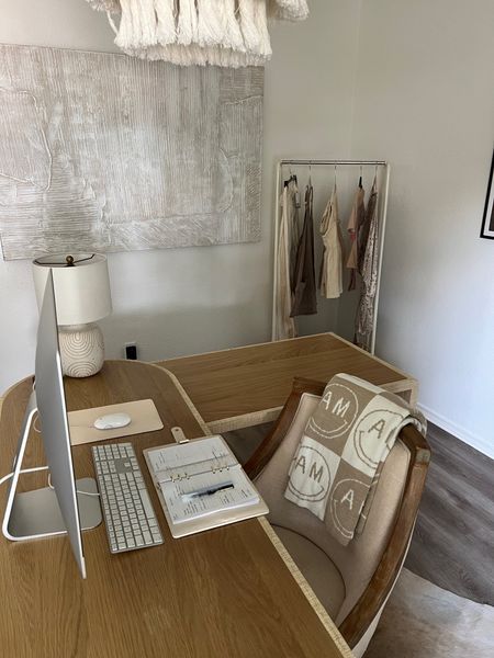 neutral home office details 🤍 
Swivel desk chair, rattan desk, clothing rack, lamp is old Anthro. 

Art is from home goods

#LTKhome