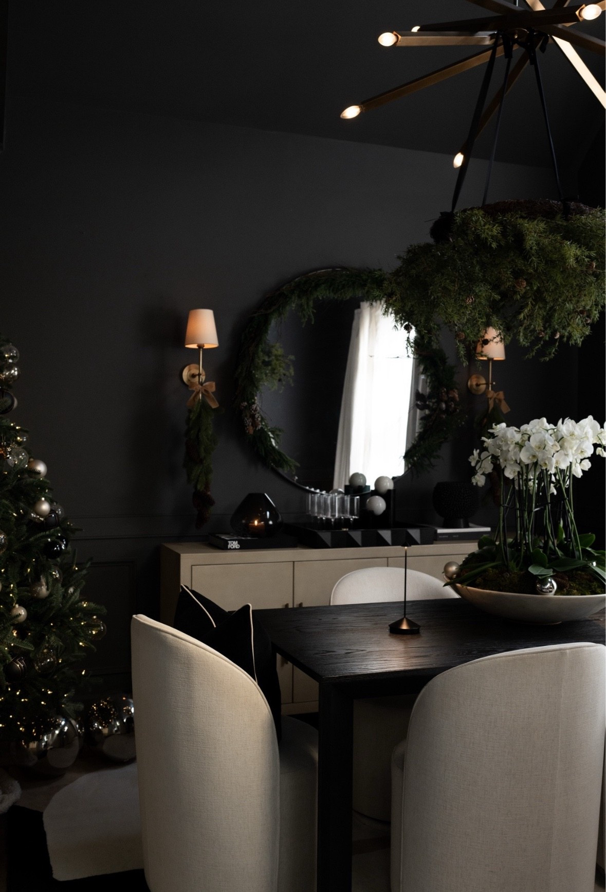 This season I focused on pairing classic holiday greens with modern, sculptural decor. The oversized mirror wrapped in cedar, the streamlined buffet accessories, the contemporary chandelier, and the soft curved dining chairs all help balance warmth with clean lines. Even the ornaments and tabletop greens add depth without overwhelming the space. It’s a collected look that still feels festive and sophisticated! 

#LTKSeasonal #LTKHoliday #LTKHome