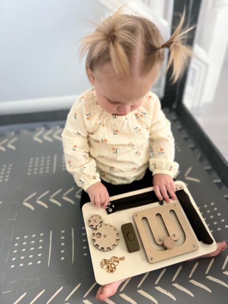 A new favorite. 
This busy board is perfect for Montessori loving babies. It is VERY well built. Everything is on nice and tight. And everything works so well. My 13-month-old and my 2 and a half year old both love it. 
Great gift for a one year old and a toddler Christmas gift.  

#LTKGiftGuide #LTKkids #LTKbaby