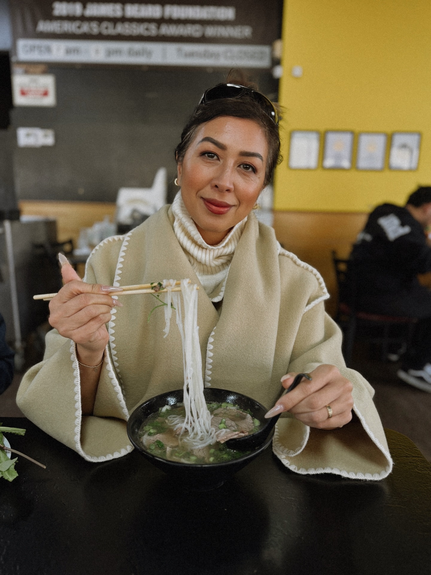 Hands-down the best pho in the world. 🍜 Pairs well with my wool scarfed jacket. See my #ltk shop, link in bio.