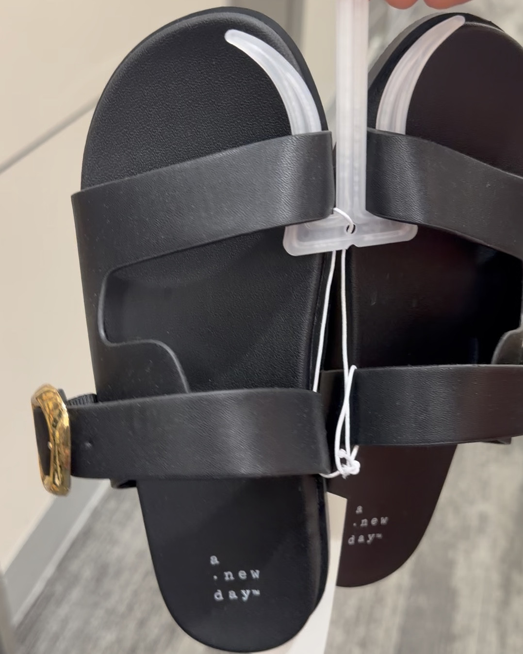 Flat slip on sandal for woman in black & raffia woven. 

Gold buckle detail adds a chic style to any look. 

Cushioned insole, open, rounded toe,adjustable buckle strap  

Memory foam | trendy sandals | trendy shoes | women’s shoes | affordable | budget | comfortable | casual | slip on | 