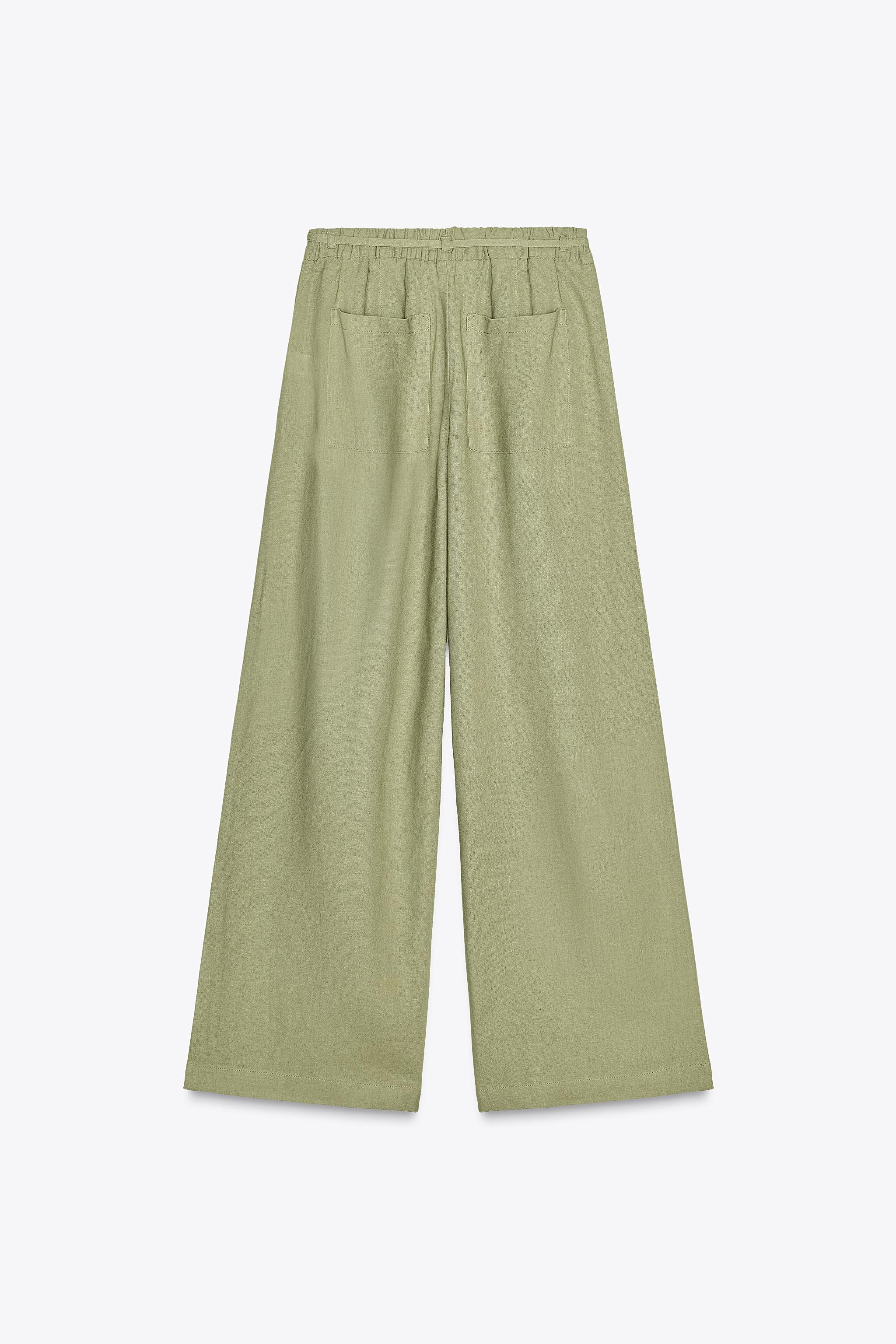 Linen trousers. High waist with belt loops and elasticated waistband. Side pockets and patch pock... | Zara UK