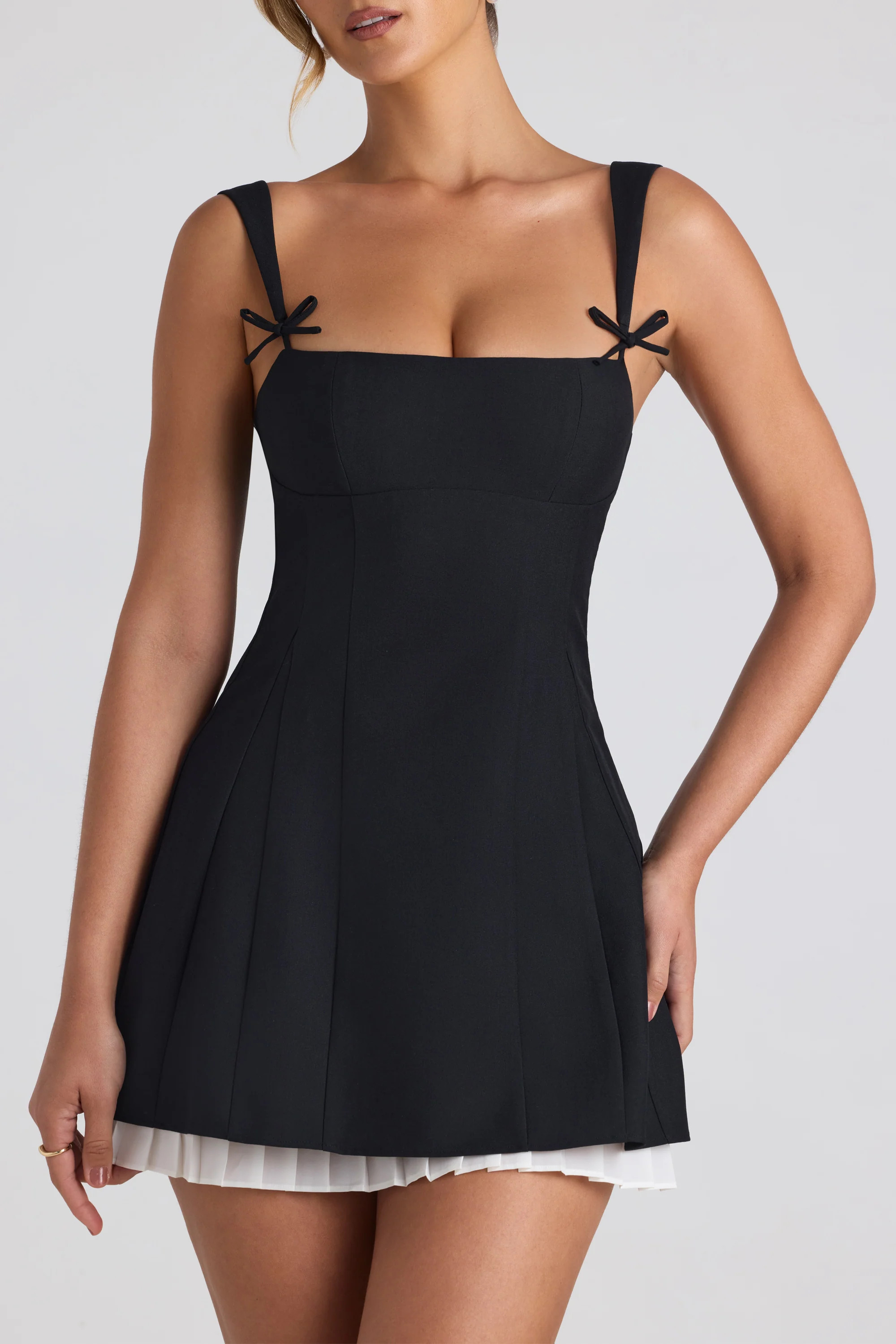 Bow-Embellished Pleated A-Line Mini Dress in Black | Oh Polly