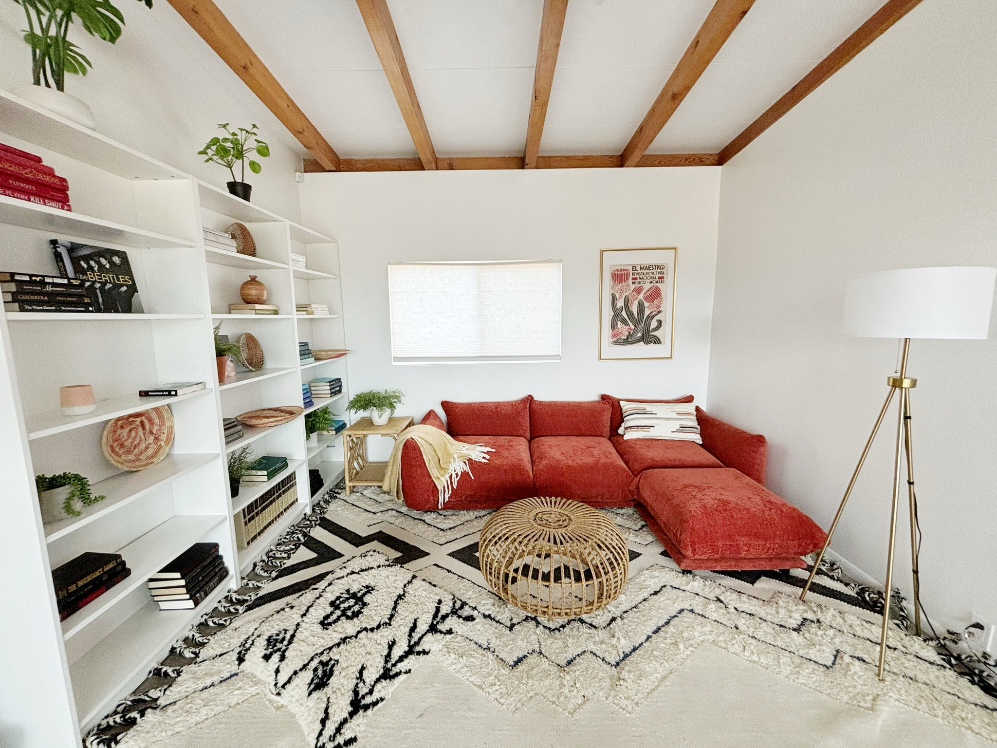 Cozy living room set up in our desert home with this rust colored modular sectional and Moroccan rug.  Still filling the shelves with books and other finds.  For a vacation home you can go a little more bold with the design.  

#LTKTravel #LTKHome