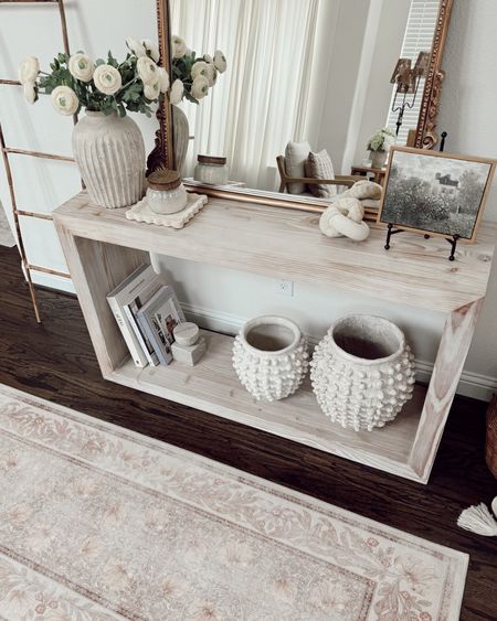 ENTRY TABLE DECOR ✨

I love that this table is a timeless shape, fun to decorate, and a statement when we walk through our front door 😌 

+ two vases on the bottom: Anthro
+ decorative books
+ marble object/bookend: Target 
+ bamboo ladder: Amazon
+ vase on top: pottery barn
+ faux flowers: Amazon
+ mirror: Anthro 
+ easel with frame: Amazon
+ washable rug

everything here is linked in my bio! What do you think of it? I feel like since switching the runner here, feels like a new space despite me not switching the decorative accents on my table 🤯




#LTKfindsunder50 #LTKhome #LTKfindsunder100
