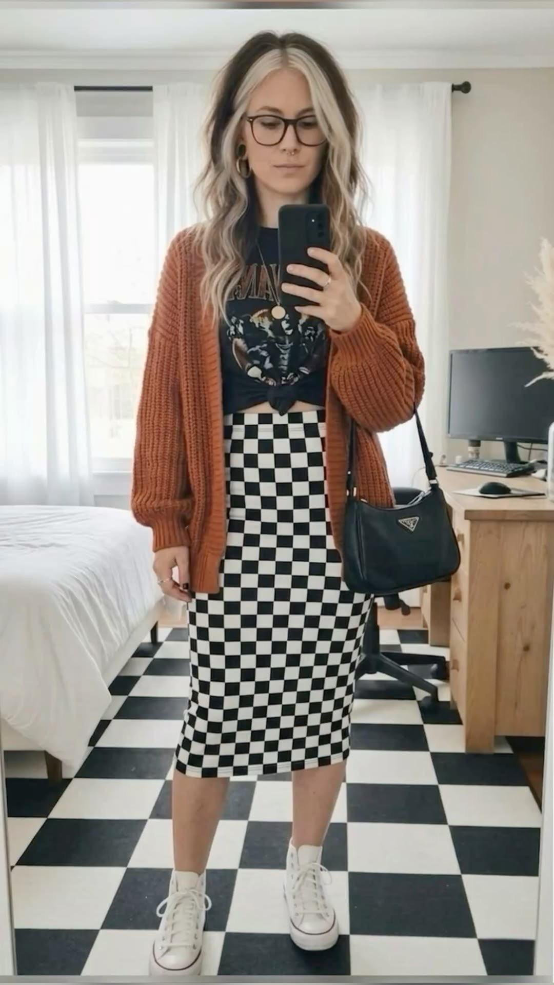 A little bit grunge, a little bit cozy! 🍂 Obsessed with how this chunky burnt orange cardigan adds the perfect pop of color to a monochrome look. I styled it with a high-waisted checkered midi skirt, a knotted vintage band tee, and classic white high-top sneakers for that effortless streetwear vibe. This is definitely going to be my transition uniform.

#LTKootd #LTKSeasonal #LTKMidsize