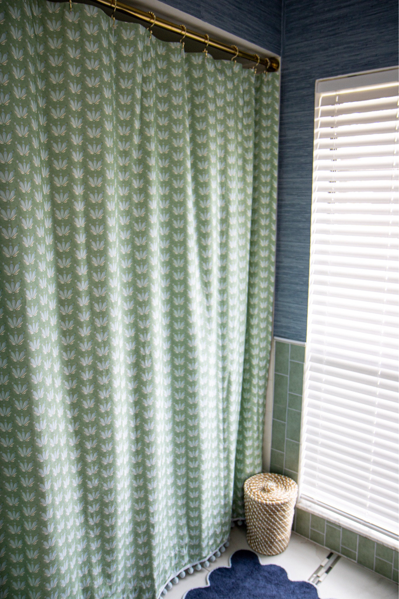 The boys bathroom update is finally complete. 💚💙 A weekend project that turned into MONTHS of hunting for the perfect shower curtain.. I did not think that would be the hardest part of this project! 🫠 Lucky for you I sourced this custom shower curtain from @pepperhome & it arrived DAYS after I ordered it! The rest of the project just took me a weekend - paint on the cabinet, peel & stick @socialsociety wallpaper, a new light & mirror! 

Boys bathroom, nautical bathroom, blue and white, green and blue home decor, grass cloth wallpaper, scalloped mirror, scalloped picture frame, #pepperhome #SLpartner #serenaandlily #socialsociety 

#LTKkids #LTKfamily #LTKhome