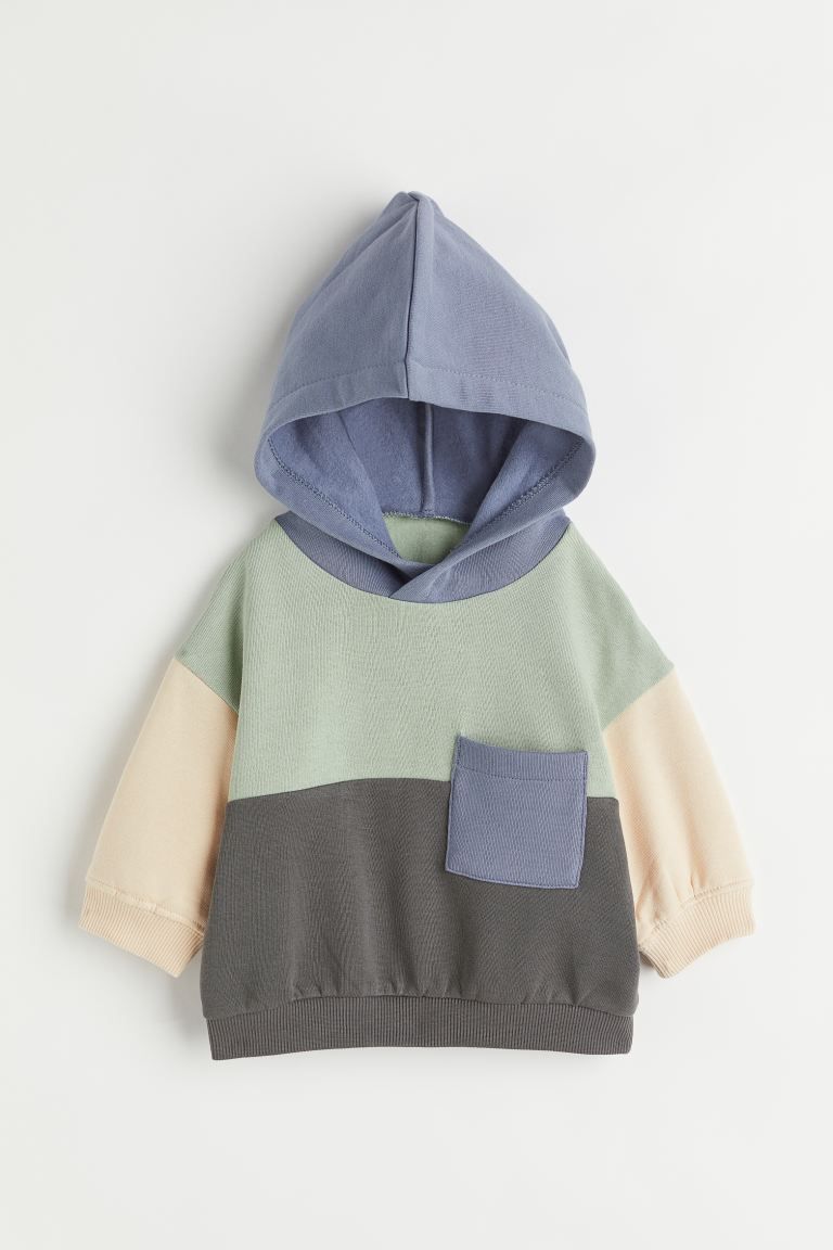 Block-coloured hoodie in sweatshirt fabric with a soft brushed inside. Hood with a wrapover front... | H&M (US + CA)