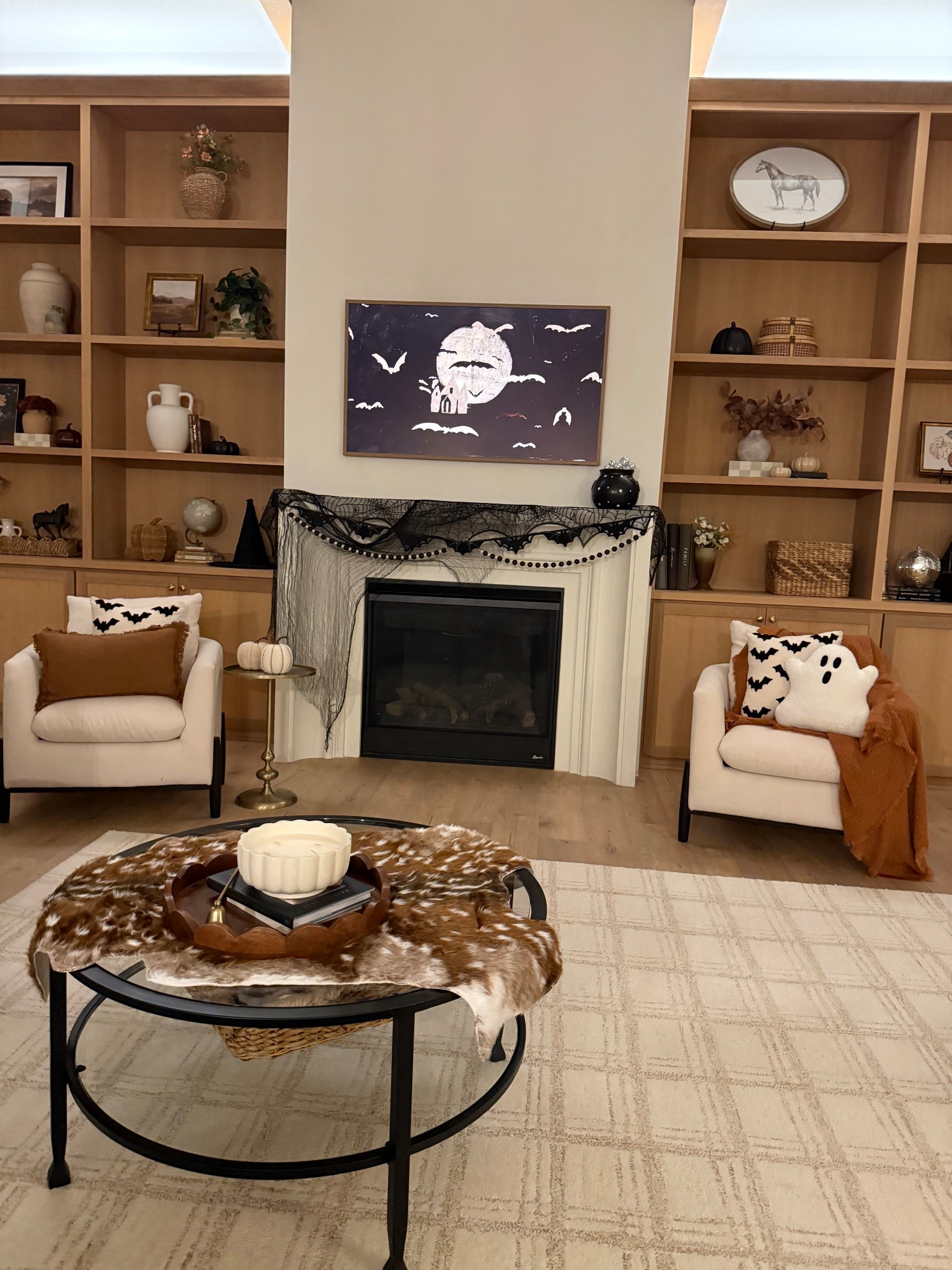 Halloween Decor! Pottery barn black metal table, neutral area rug! Fall decor ideas, Halloween mantel! 

#LTKHalloween #LTKHome #LTKSeasonal