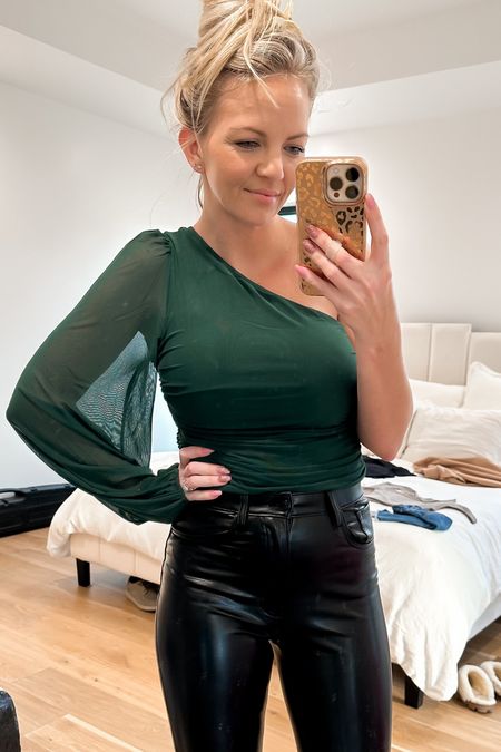 Another fun holiday outfit! So far this is the only top from Amazon that I’ve liked, and it’s so good! The fabric is soft and nice and the fit is good. I’m in a medium so I’d say it’s true to size especially for bodysuits. 
This emerald dark green is perfect for the holidays! 
The leather pants are so soft and stretchy , if between sizes, size up.

#LTKSeasonal #LTKHoliday #LTKxAF