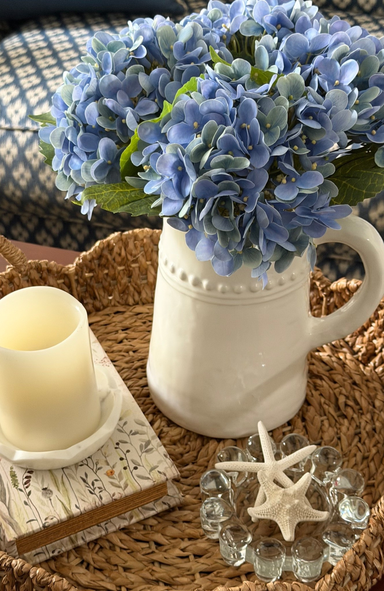 A simple tray makes a space feel finished without overthinking it. Faux hydrangeas, a candle layered on books, and a small glass dish with something personal.

 
🏠 I share real-life decor, home finds, and organization for spaces that are pretty, not perfect. 💫

#LTKHome #LTKdayinmylife #LTKSeasonal