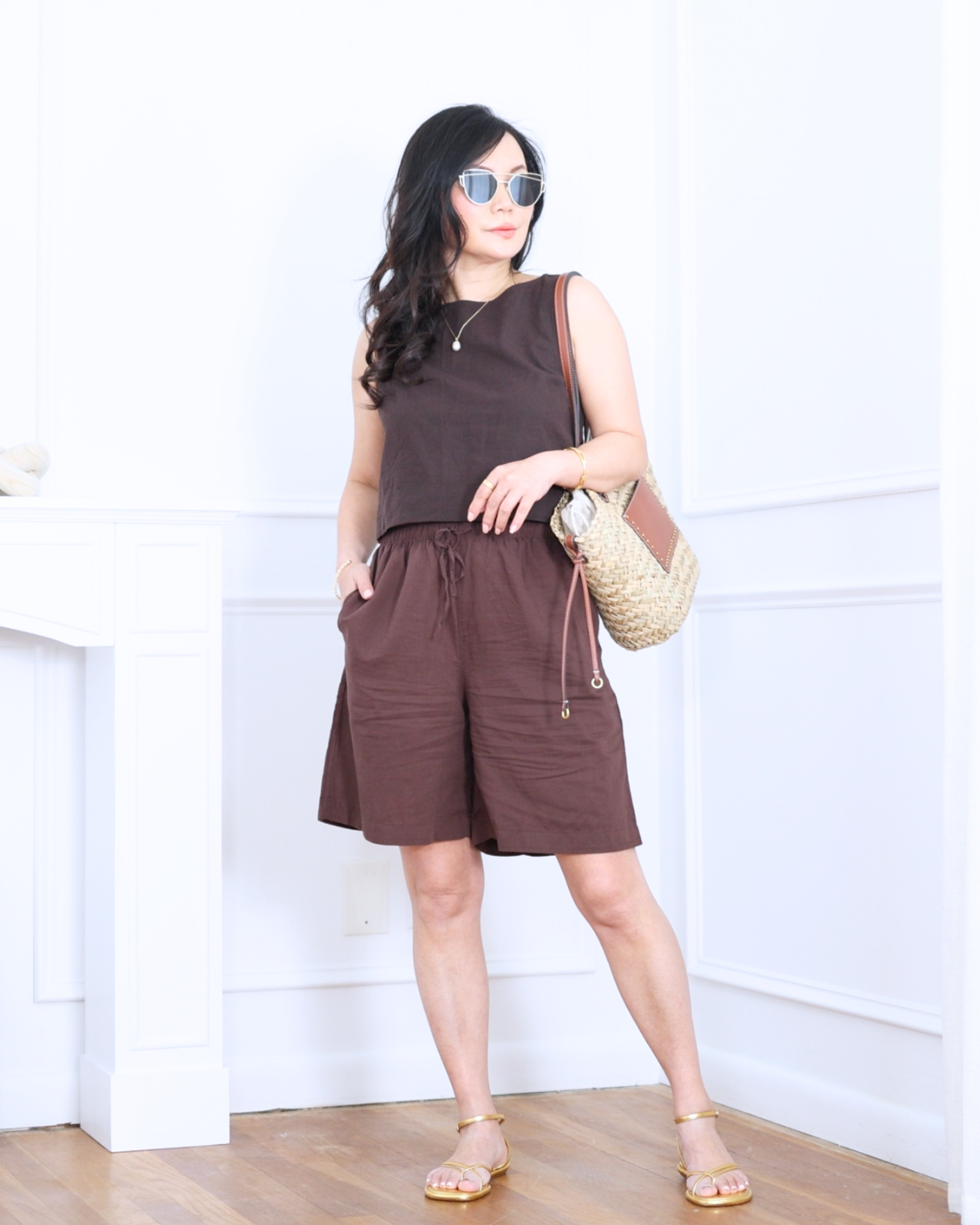 Brown linen shorts from Uniqlo paired with a brown shell tank from GAP and gold sandals from BR Factory — warm neutrals, easy layers, and an effortlessly chic summer look. I'm 5'2, wearing size S. 

 #LTKootd #LTKOver40 #LTKPetite