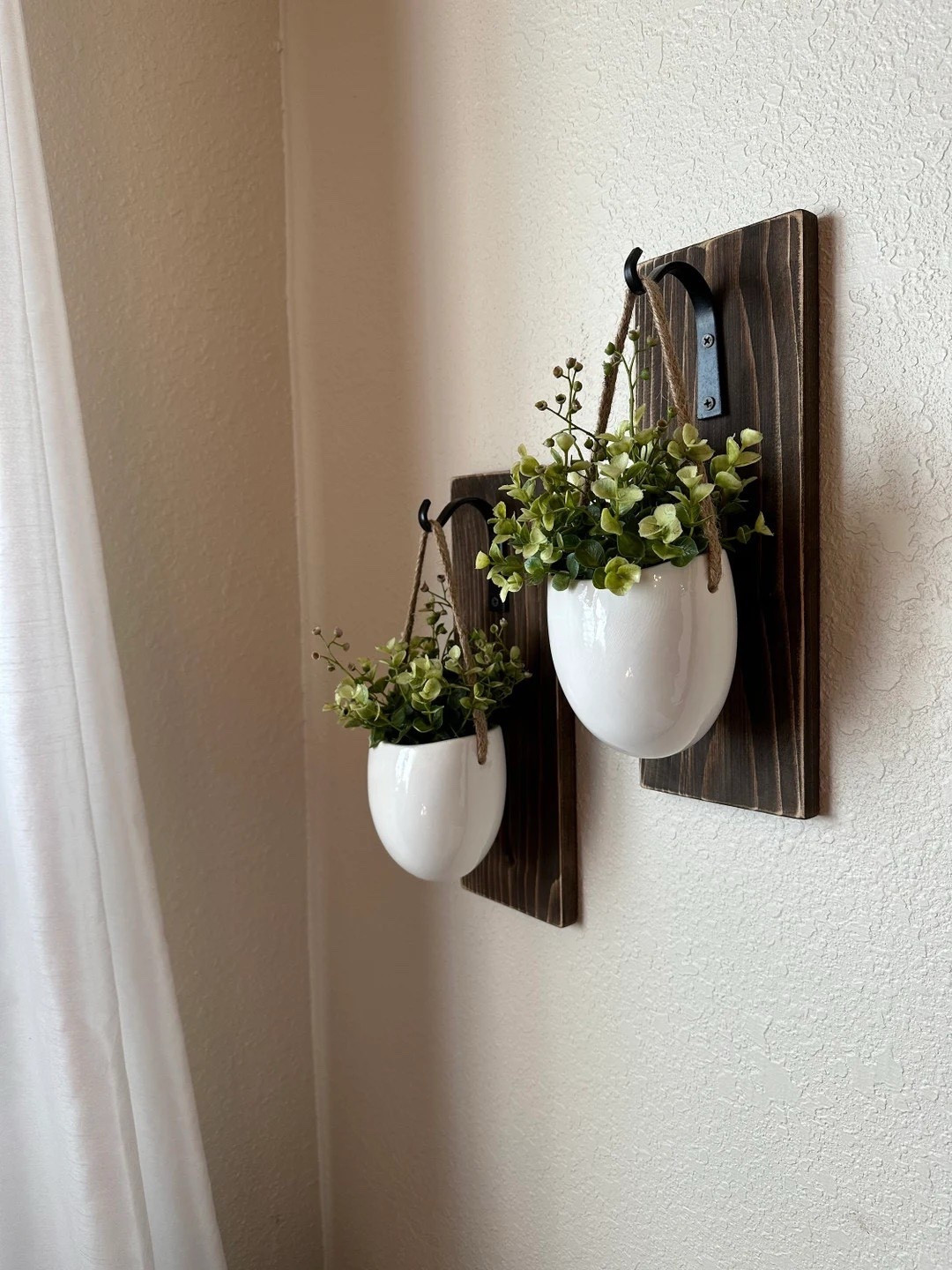 Bring effortless farmhouse charm to your walls with these ceramic wall planters by CountryHomeandHeart. Featuring beautifully stained wood, classic white ceramic pockets, and sturdy Amish-made black iron hooks, this set of two is perfect for adding greenery and warmth to any space. The neutral design blends seamlessly into any room, while the upcycled elements make it a thoughtful, sustainable decor choice that feels both timeless and fresh. #LTKHome #FarmhouseStyle #WallDecor #NeutralHome #RusticCharm #SustainableDecor #CozySpaces #HomeInspo

#LTKSeasonal #LTKHome