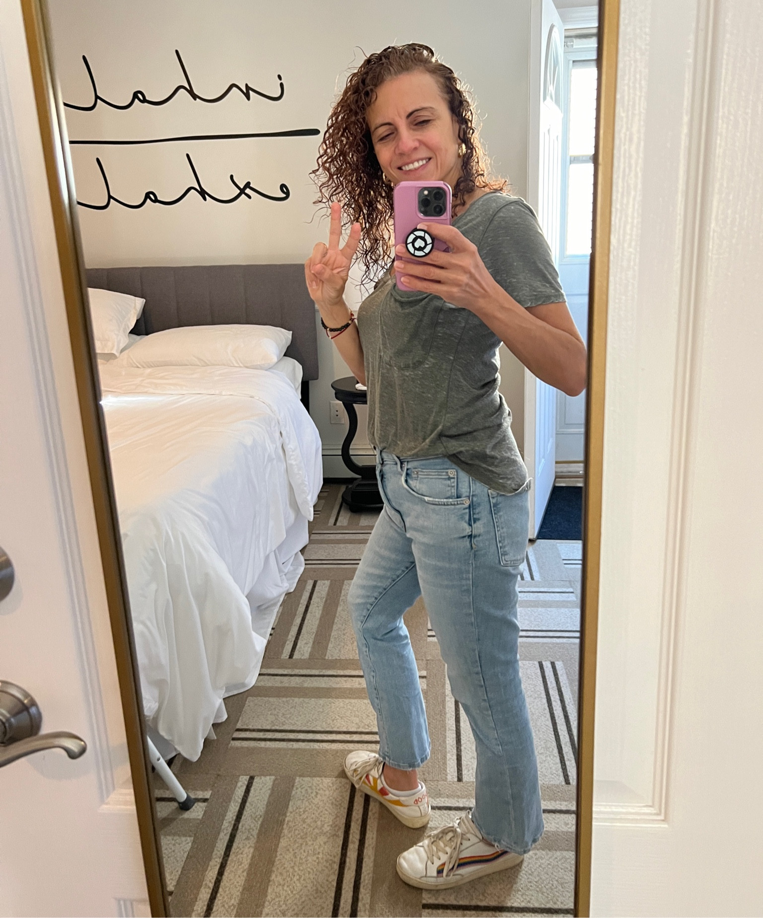 Fall fashion look for today. Olive t shirt with light wash jeans and solids good vibes rainbow sneakers. Paired with gold jewelry. Timeless fashion.  Gold mirror is perfect for checking yourself. Travel outfit 

#LTKTravel #LTKStyleTip #LTKOver40
